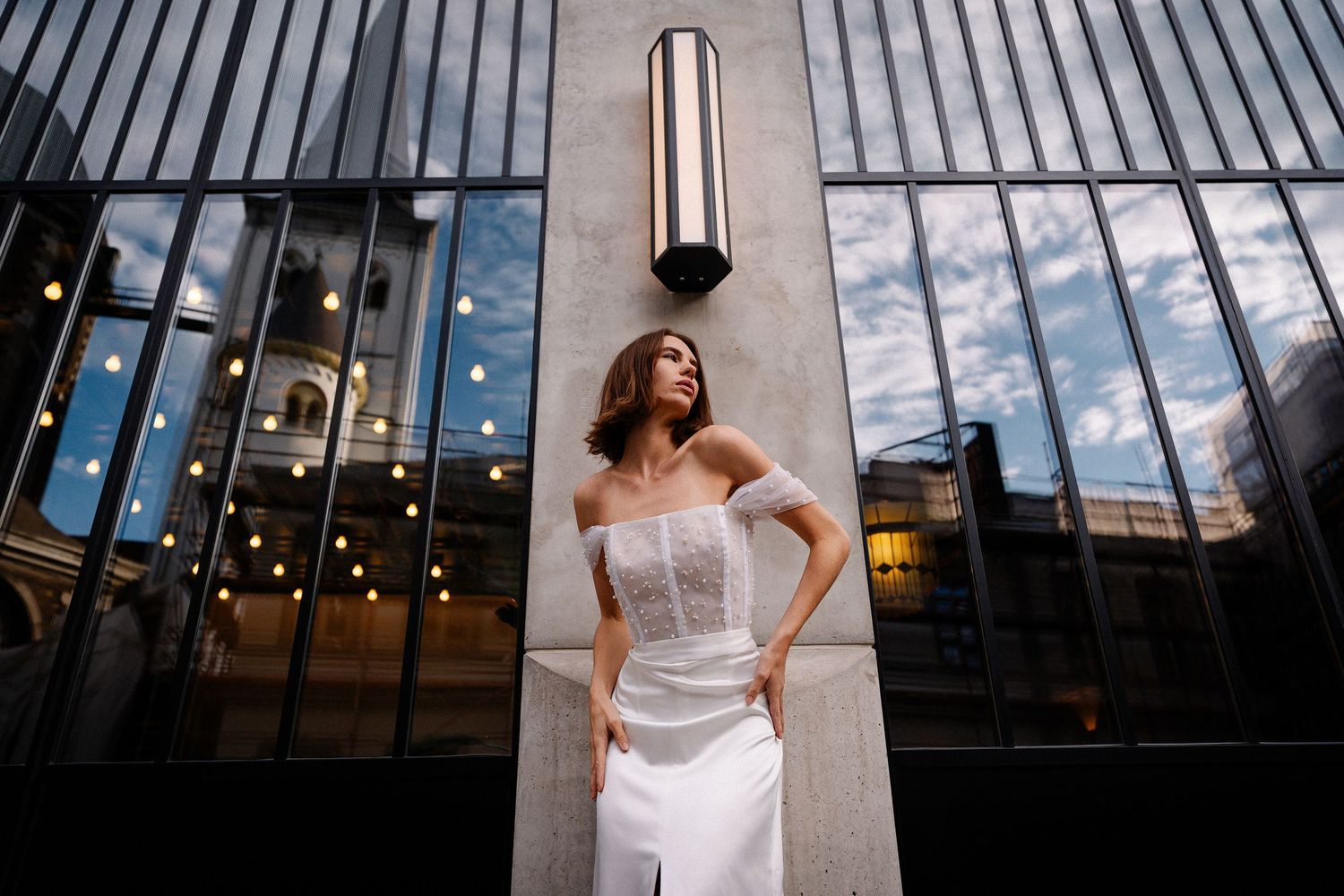 Modern architectural space with angled glass windows and warm lighting creating a sophisticated ambiance.