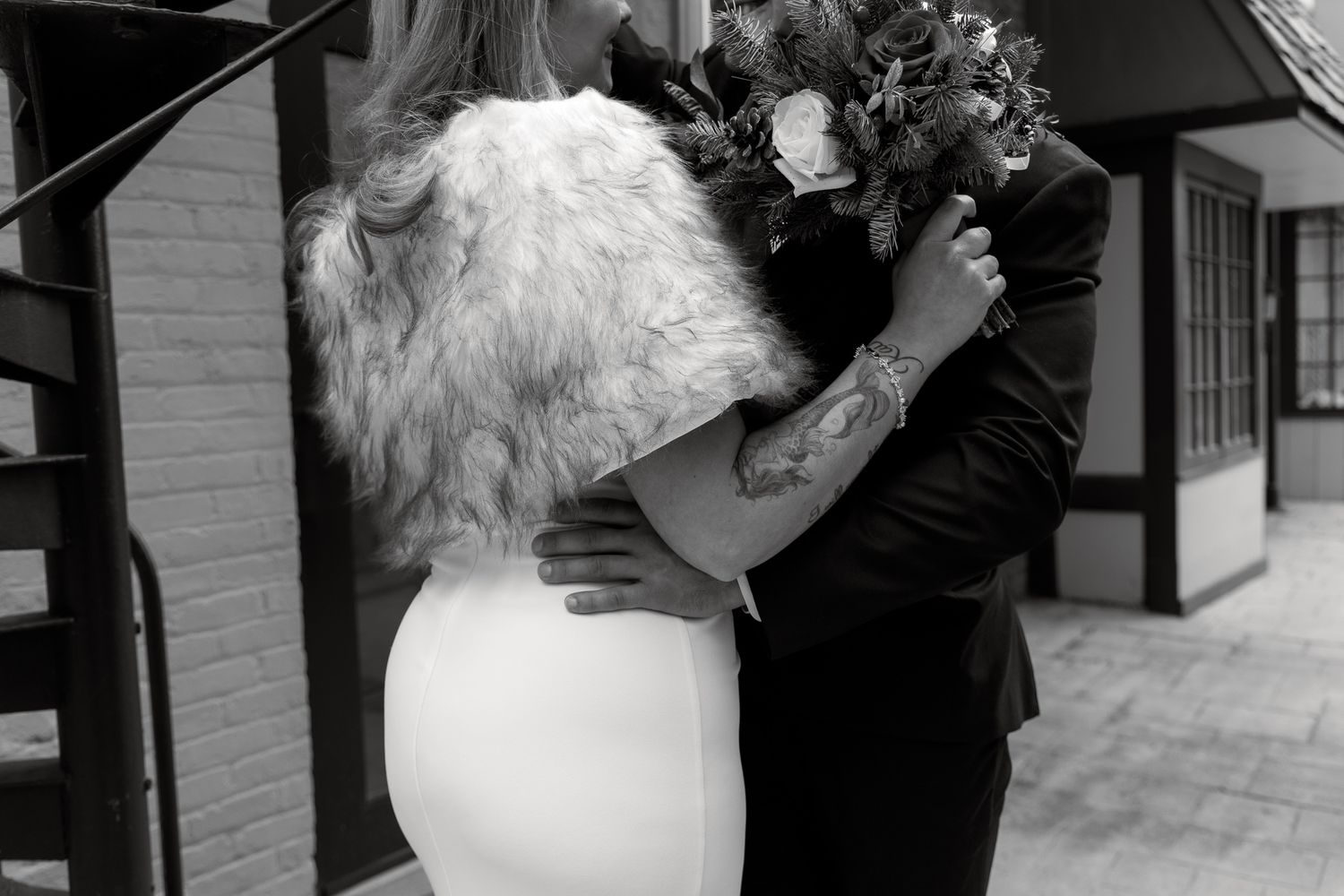 A series of black and white photos showing a wedding couple embracing and dancing together during their celebration.