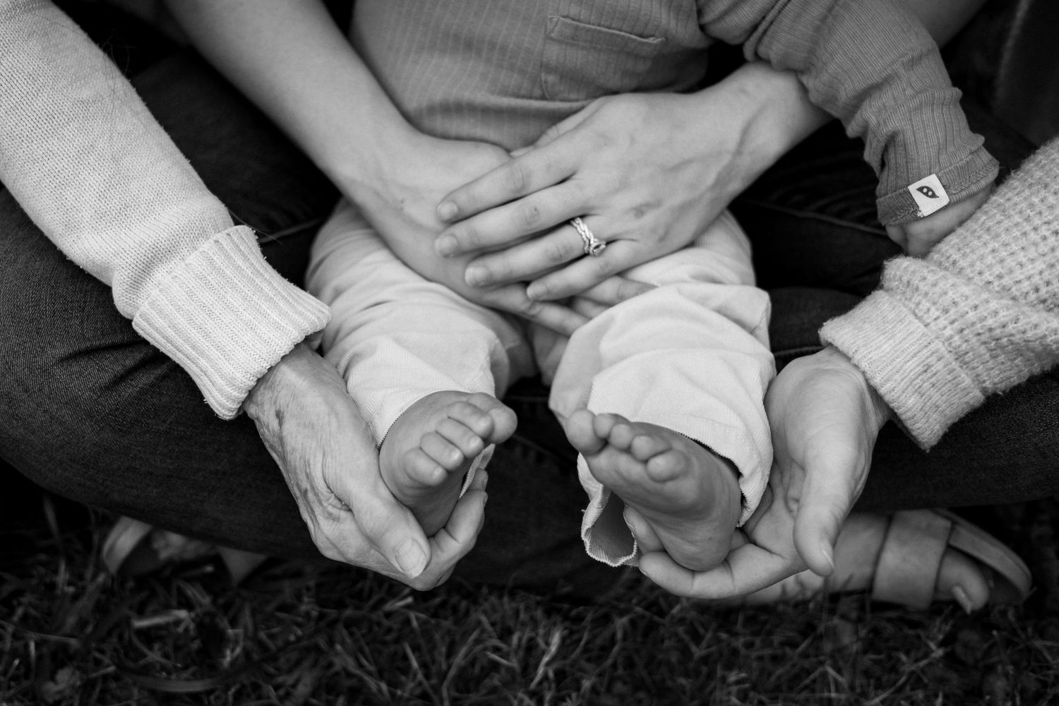Black and white photo showing hands holding small cups of coffee or espresso at a gathering.