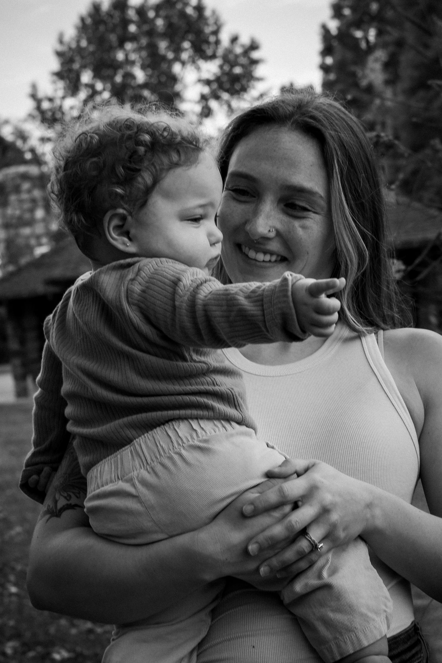 Black and white photo series showing tender moments of embrace and affection between two people outdoors.