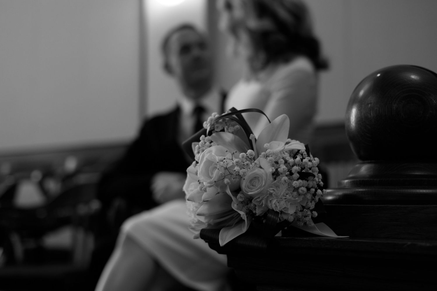 A black and white photo collage of people in various poses and activities, creating a cinematic montage effect.