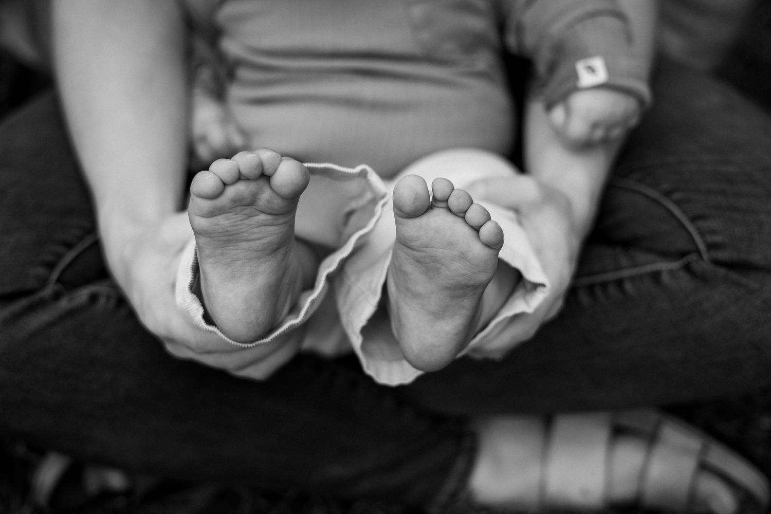Black and white photo series showing hands holding and exchanging wedding rings during a ceremony.