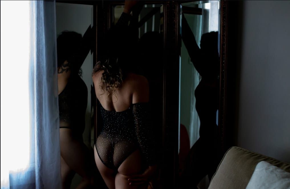 A series of silhouetted figures stand near windows in dark interior spaces.