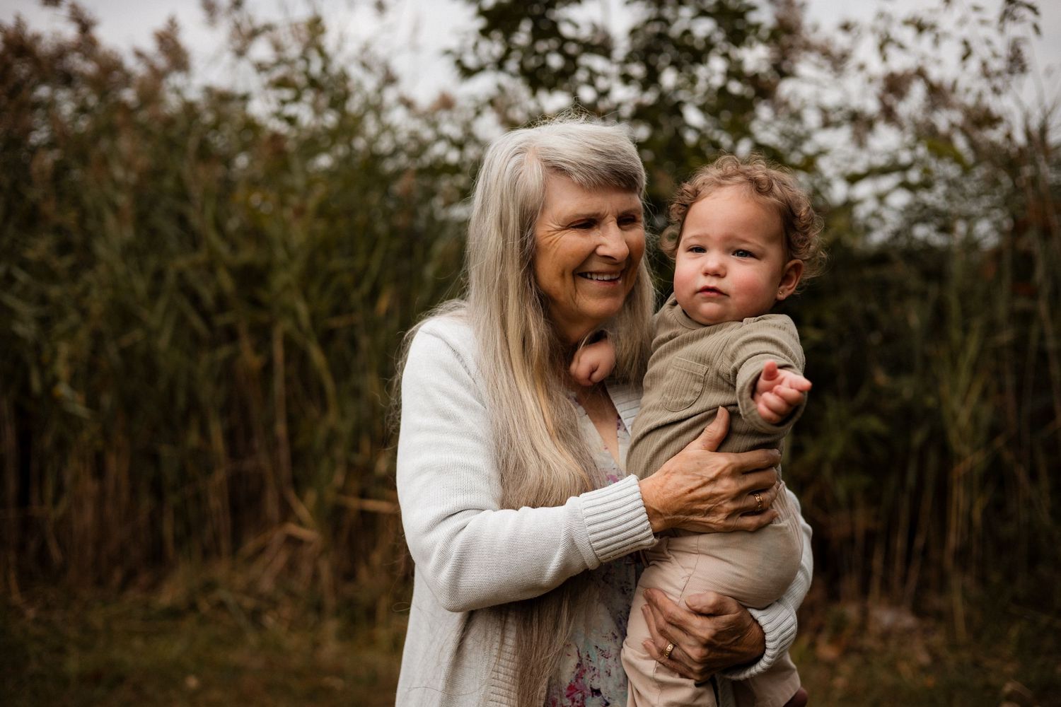 A series of candid outdoor family moments showing tender interactions between parent and child in a natural setting.