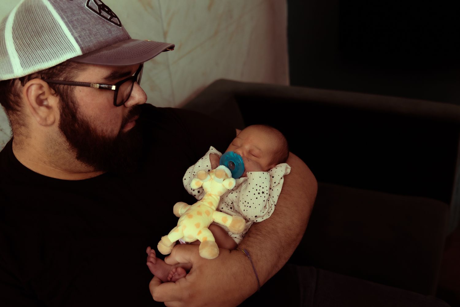 Parent and newborn baby share tender bonding moments in a series of intimate photographs.