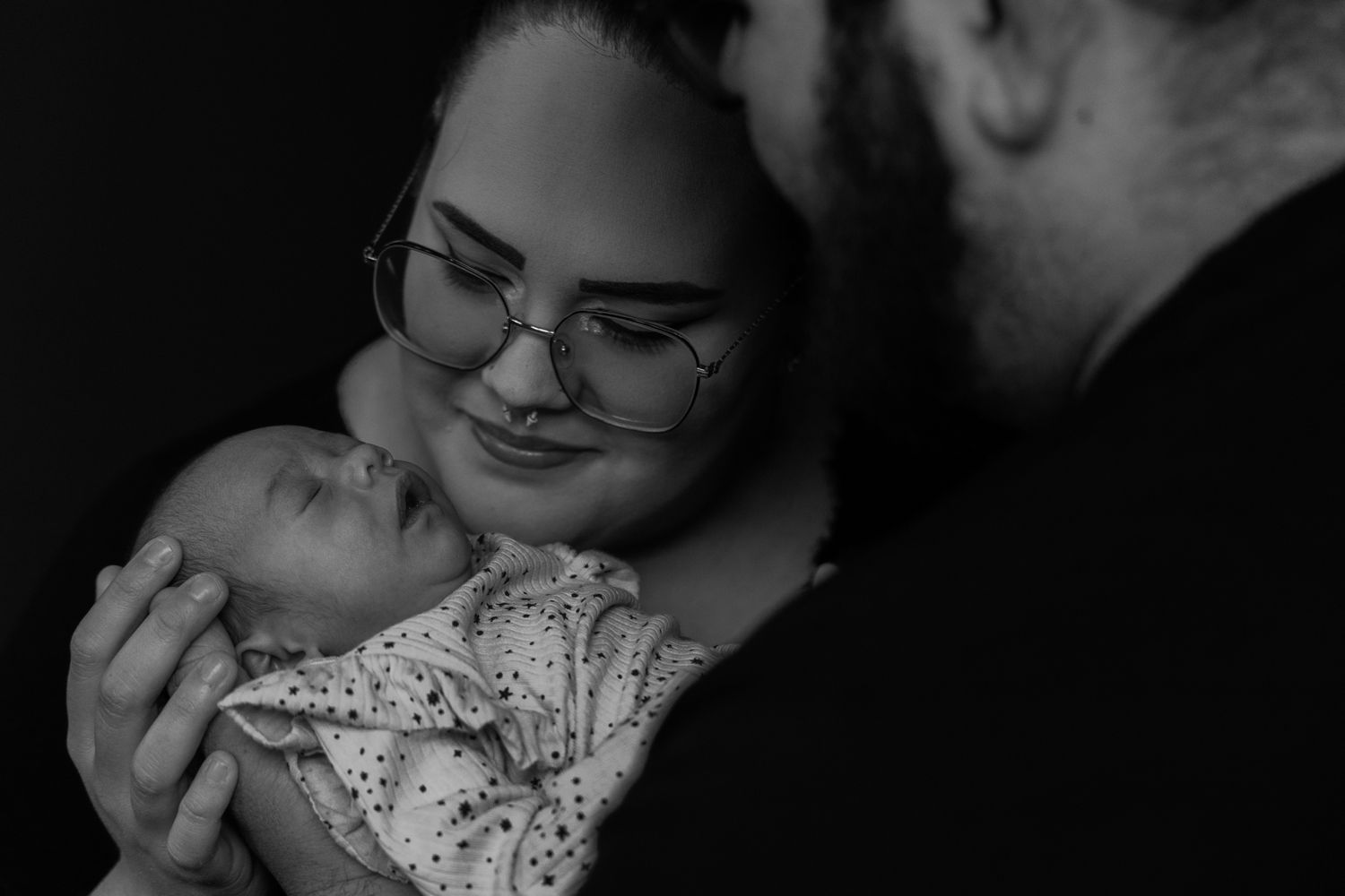 Intimate black and white portraits capture tender romantic moments between a couple in formal attire.