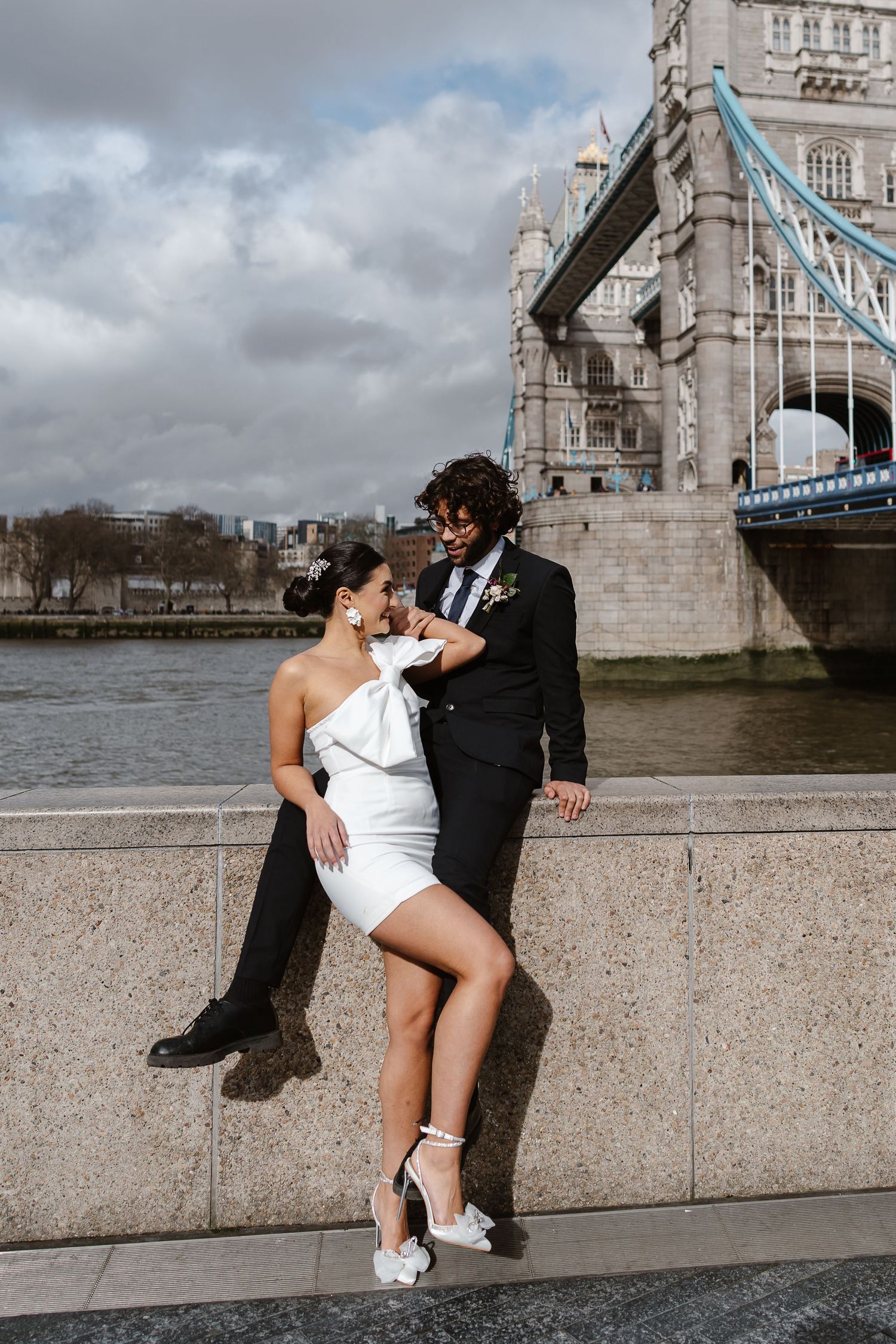 Luxury wedding photos at Tower Bridge. Bride short dress. Fun photos. Editorial. London Wedding Photographer