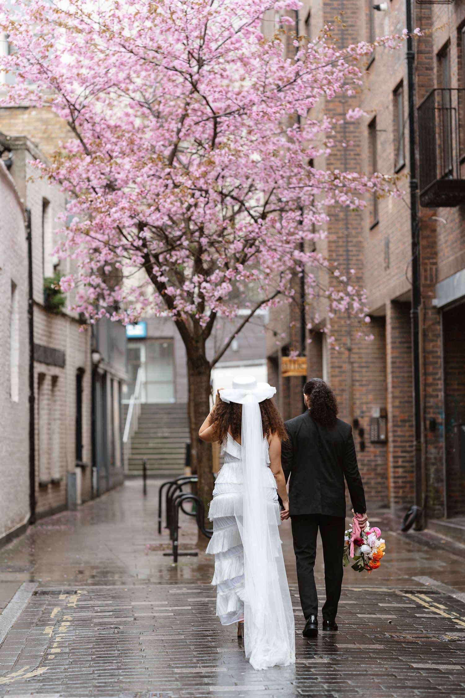 Relaxed wedding couple at The Hoxton, Holborn. London Wedding Photographer.  vibrant bouquet flowers Pink blossom London