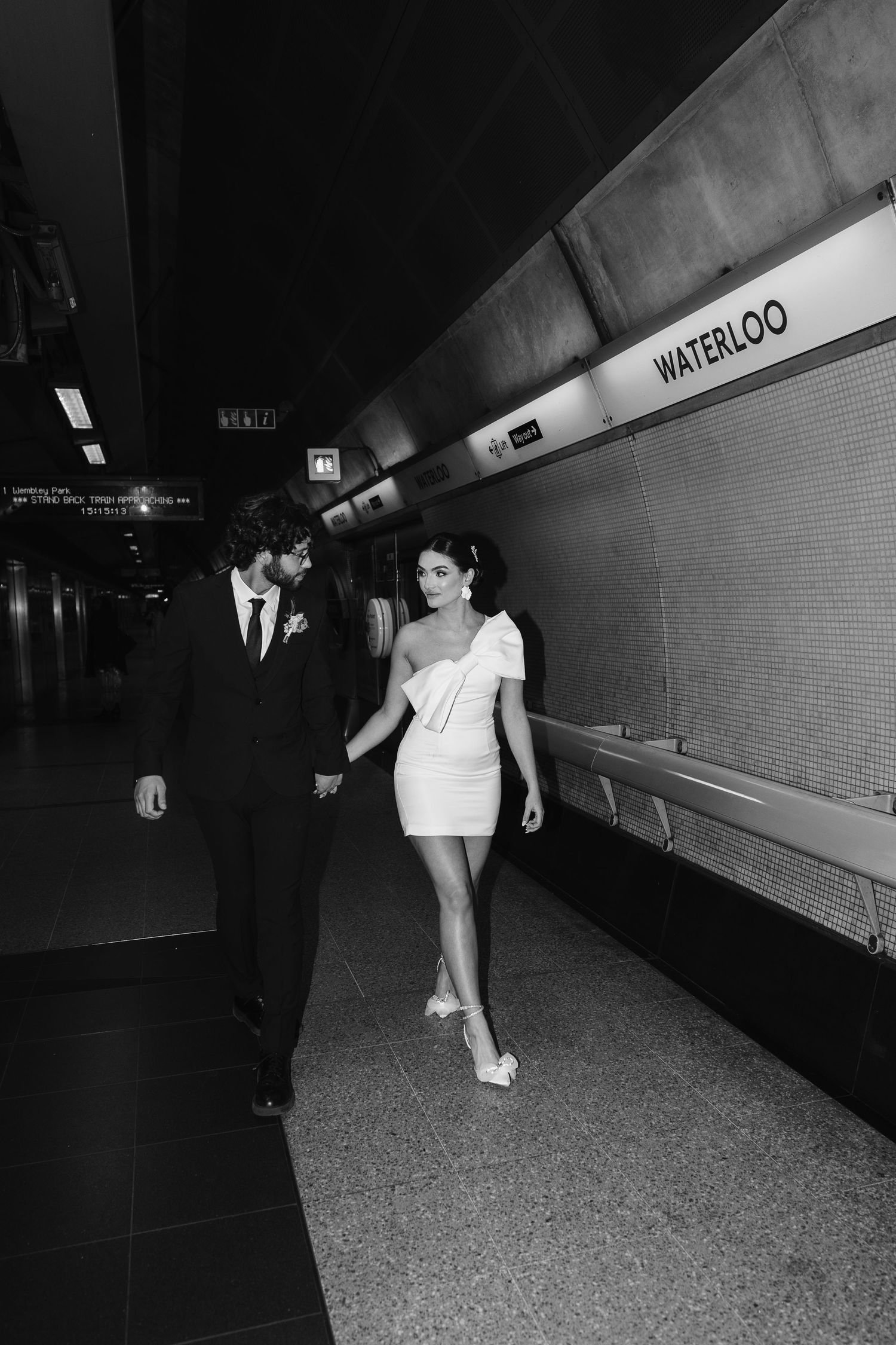 bride and groom in the London Underground Tube, direct flash editorial photography. Modern fun wedding photos. London