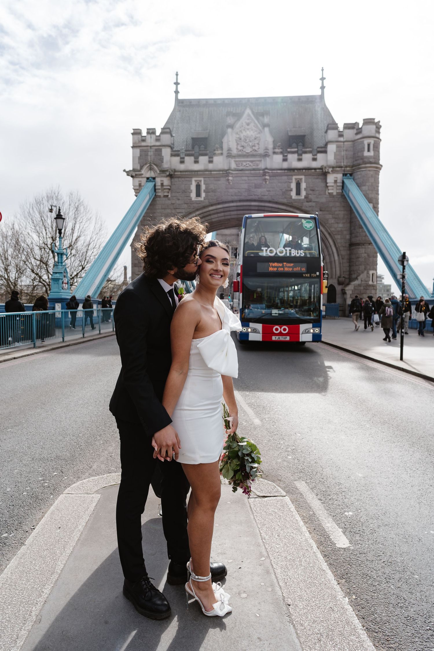 Luxury wedding photos at Tower Bridge. Bride short dress. Fun photos. Editorial. London Wedding Photographer. romantic
