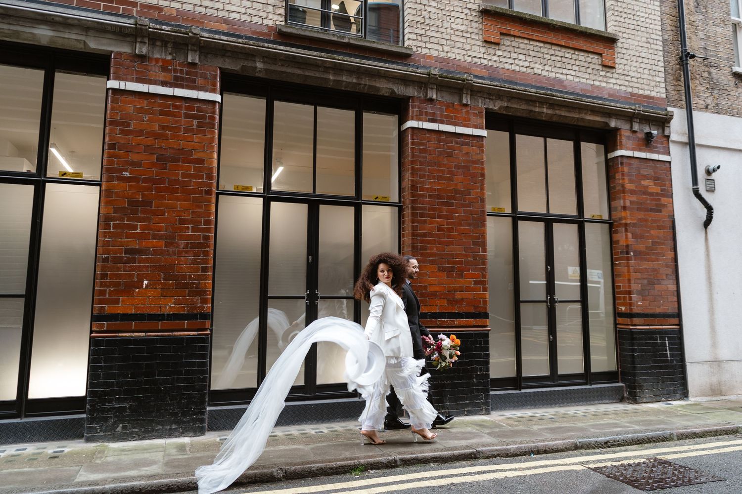 Relaxed wedding couple at The Hoxton, Holborn. London Wedding Photographer.  vibrant bouquet flowers