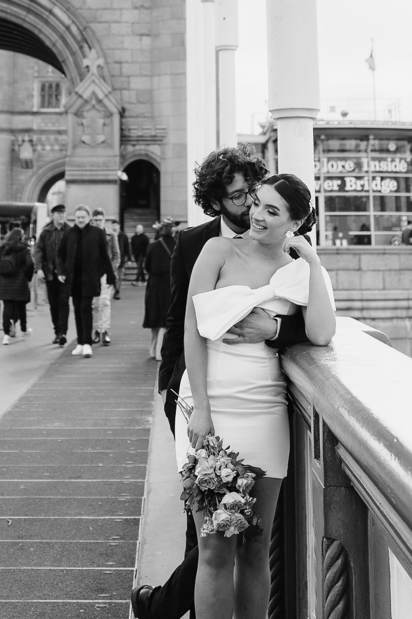Luxury wedding photos at Tower Bridge. Bride short dress. Fun photos. Editorial. London Wedding Photographer