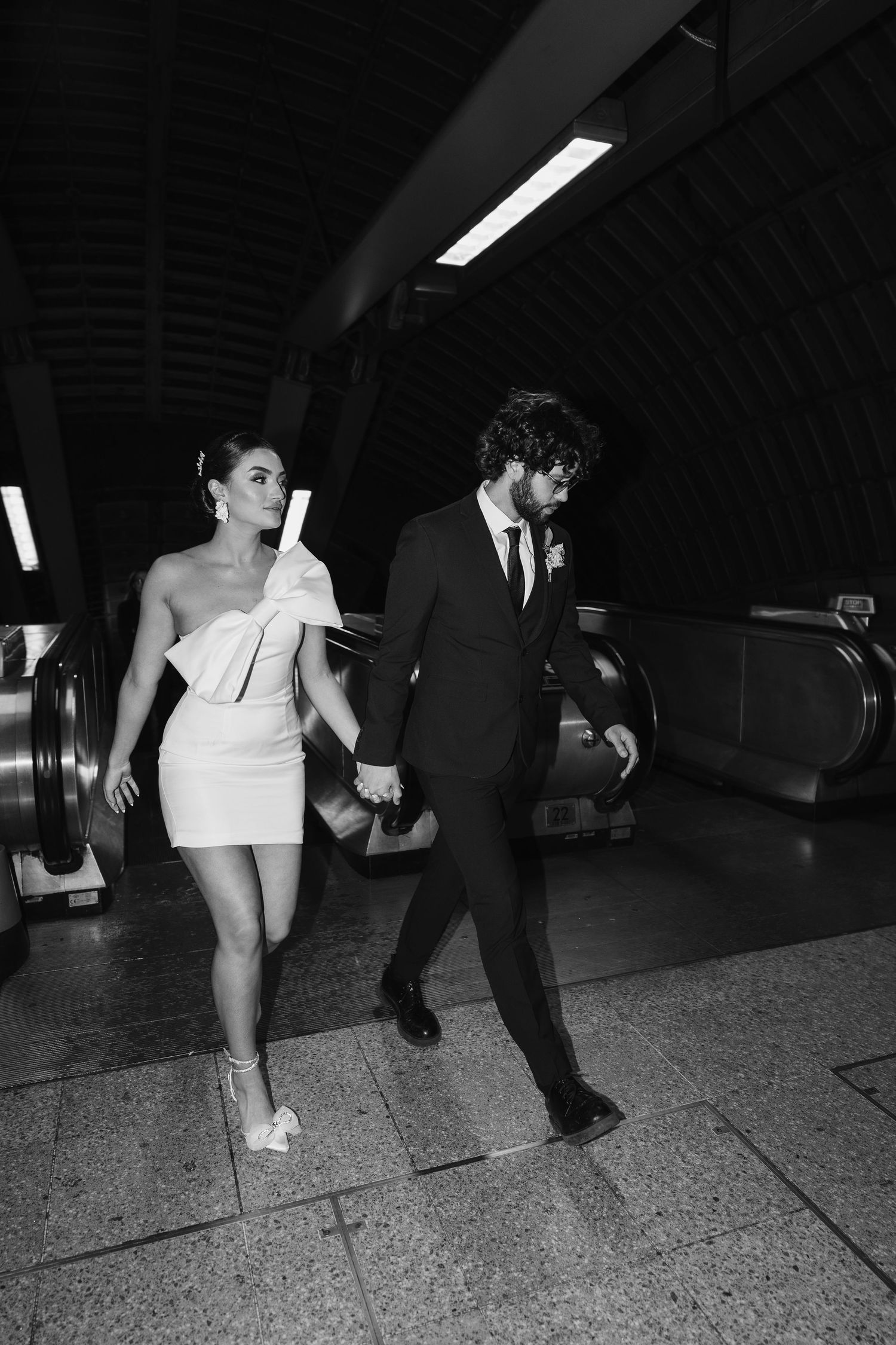 bride and groom in the London Underground Tube, direct flash editorial photography. Modern fun wedding photos. London