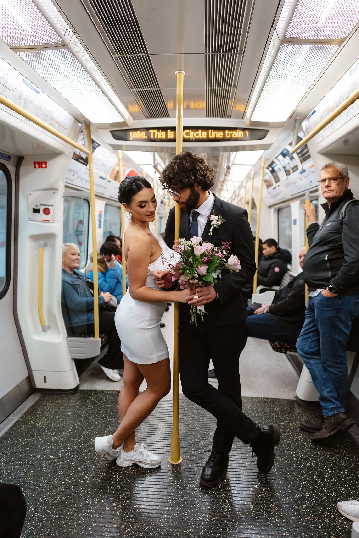 Bride and groom on London Underground tube wedding photos. Taken by London Wedding Photographer
