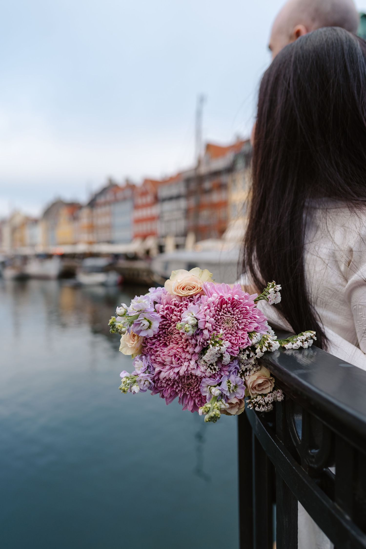 Newlyweds walking along Nyhavn Canal in Copenhagen. Denmark wedding. Scandinavian & Destination Wedding Photographer
