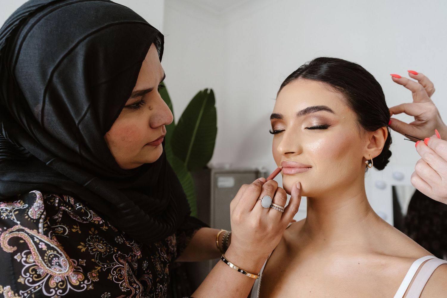 Make up artist and Hair stylist during bridal prep in London St Paul's for Wedding bridal hair and make up. London Weddi
