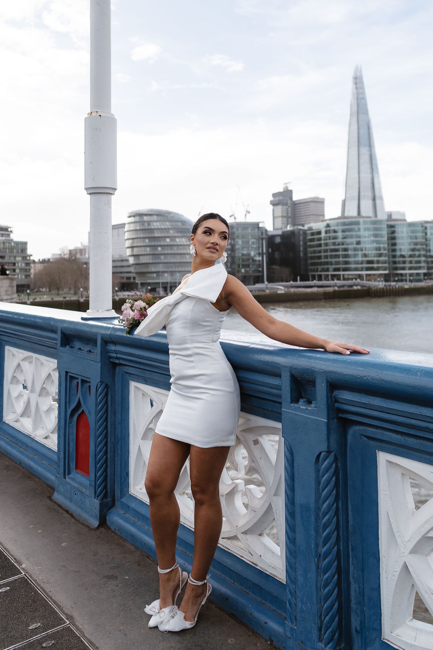 Luxury wedding photos at Tower Bridge. Bride short dress. Fun photos. The shard. Editorial. London Wedding Photographer