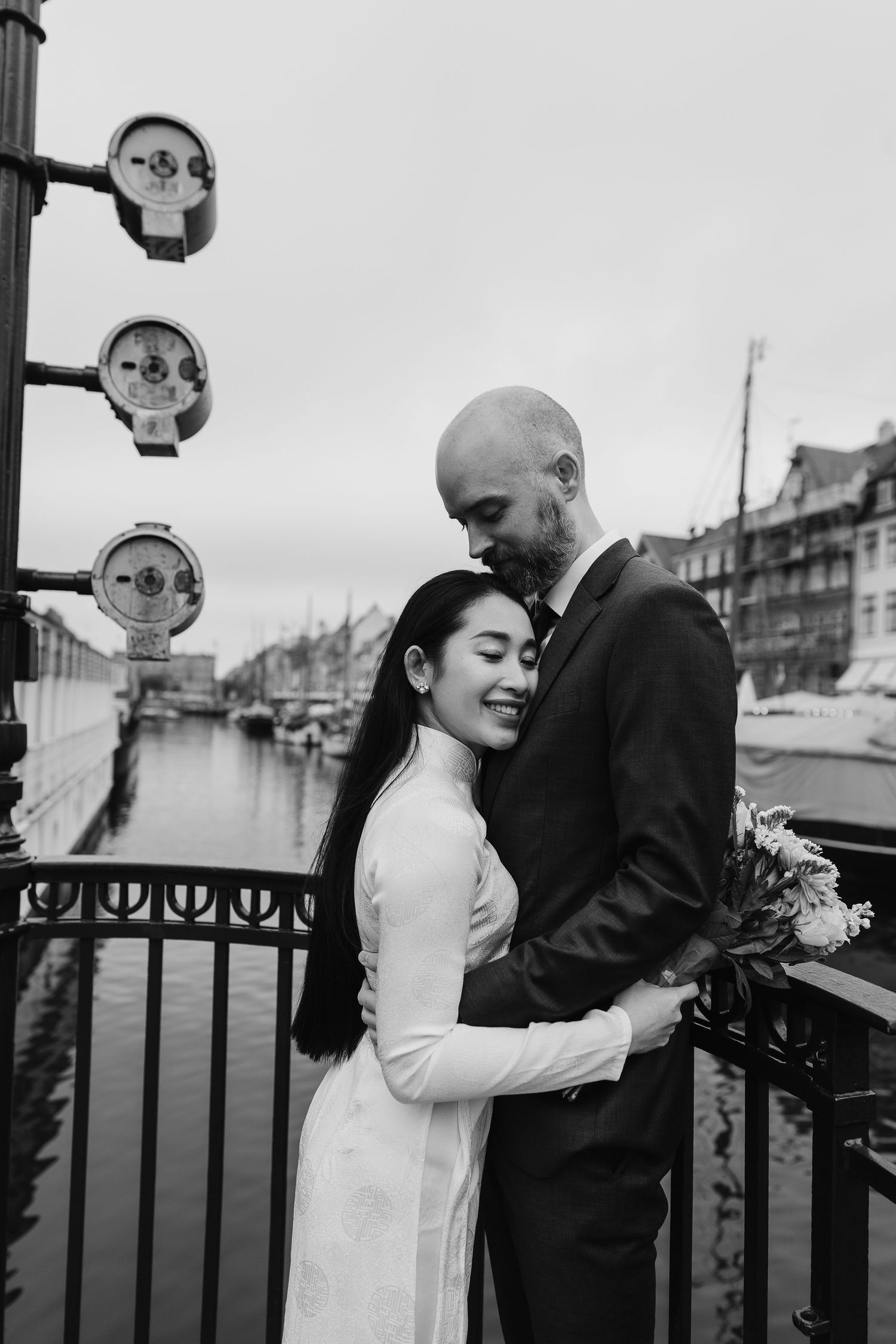 Newlyweds walking along Nyhavn Canal in Copenhagen. Denmark wedding. Scandinavian & Destination Wedding Photographer