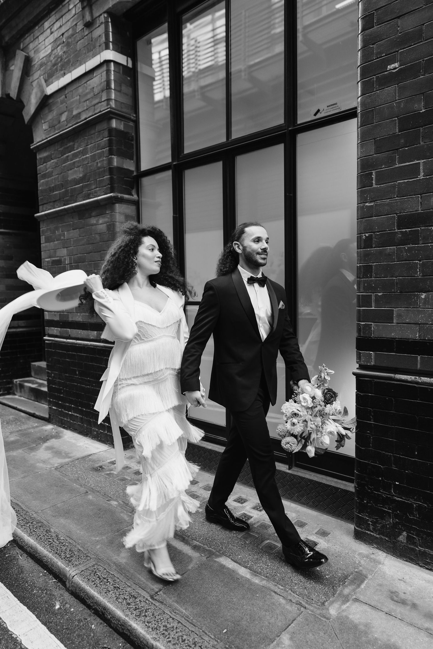 Relaxed wedding couple at The Hoxton, Holborn. London Wedding Photographer.  vibrant bouquet flowers