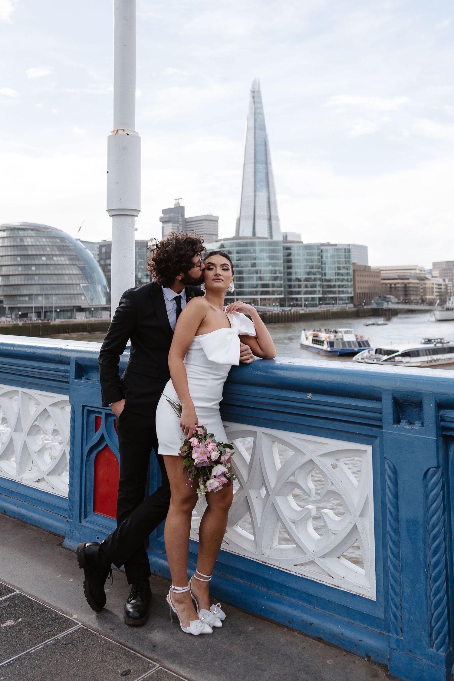 Luxury wedding photos at Tower Bridge. Bride short dress. Fun photos. The shard. Editorial. London Wedding Photographer