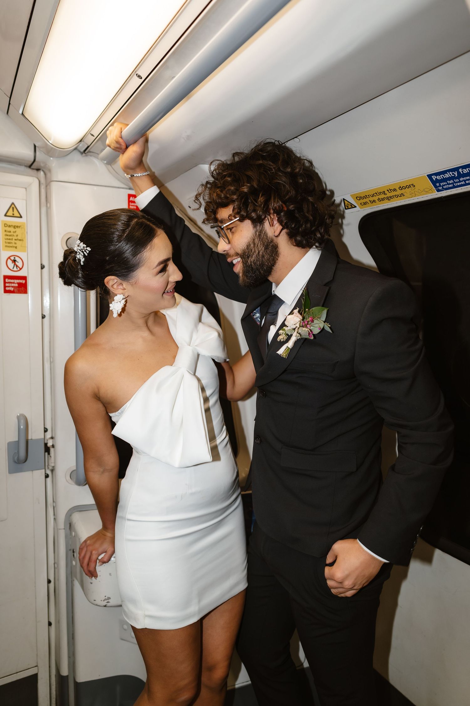 bride and groom in the London Underground Tube, direct flash editorial photography. Modern fun wedding photos. London