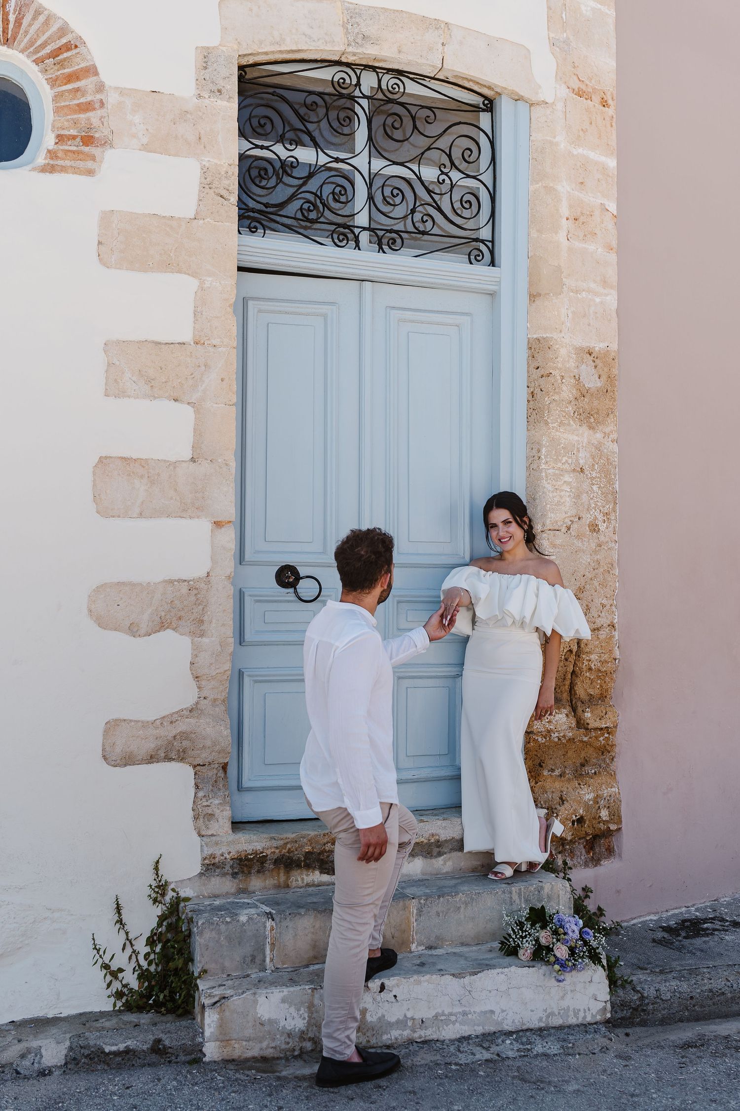 Old money pose at blue door in Chania by Crete Wedding Photographer