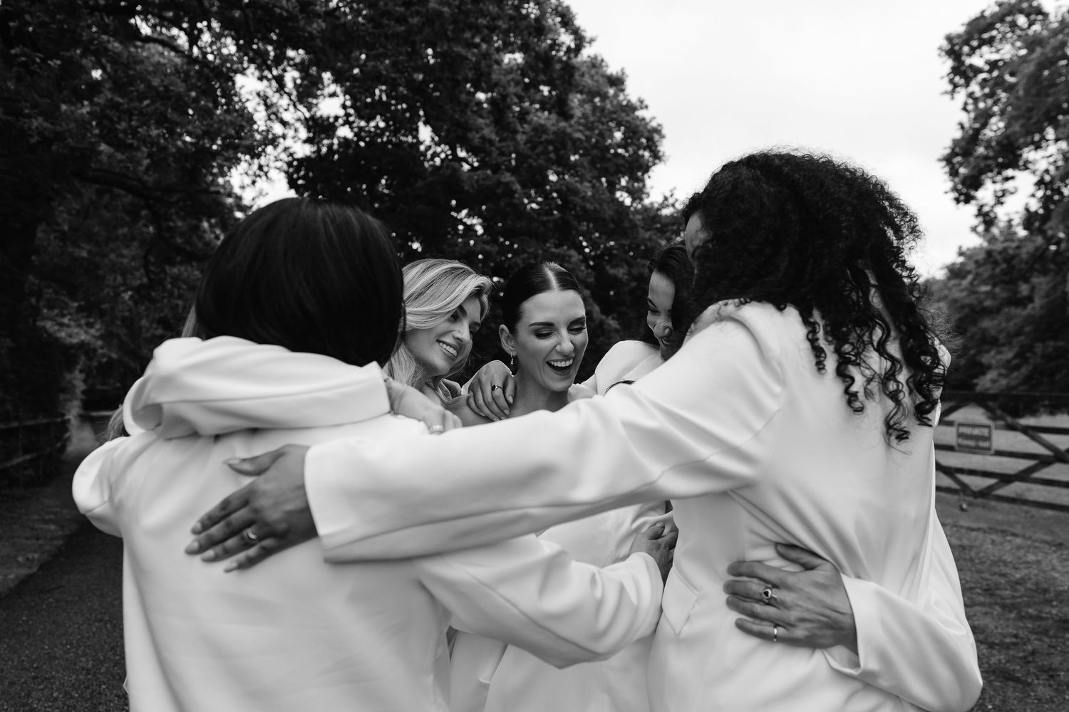 Bridesmaids embracing the bride. relaxed and fun vibes. Wedding photos