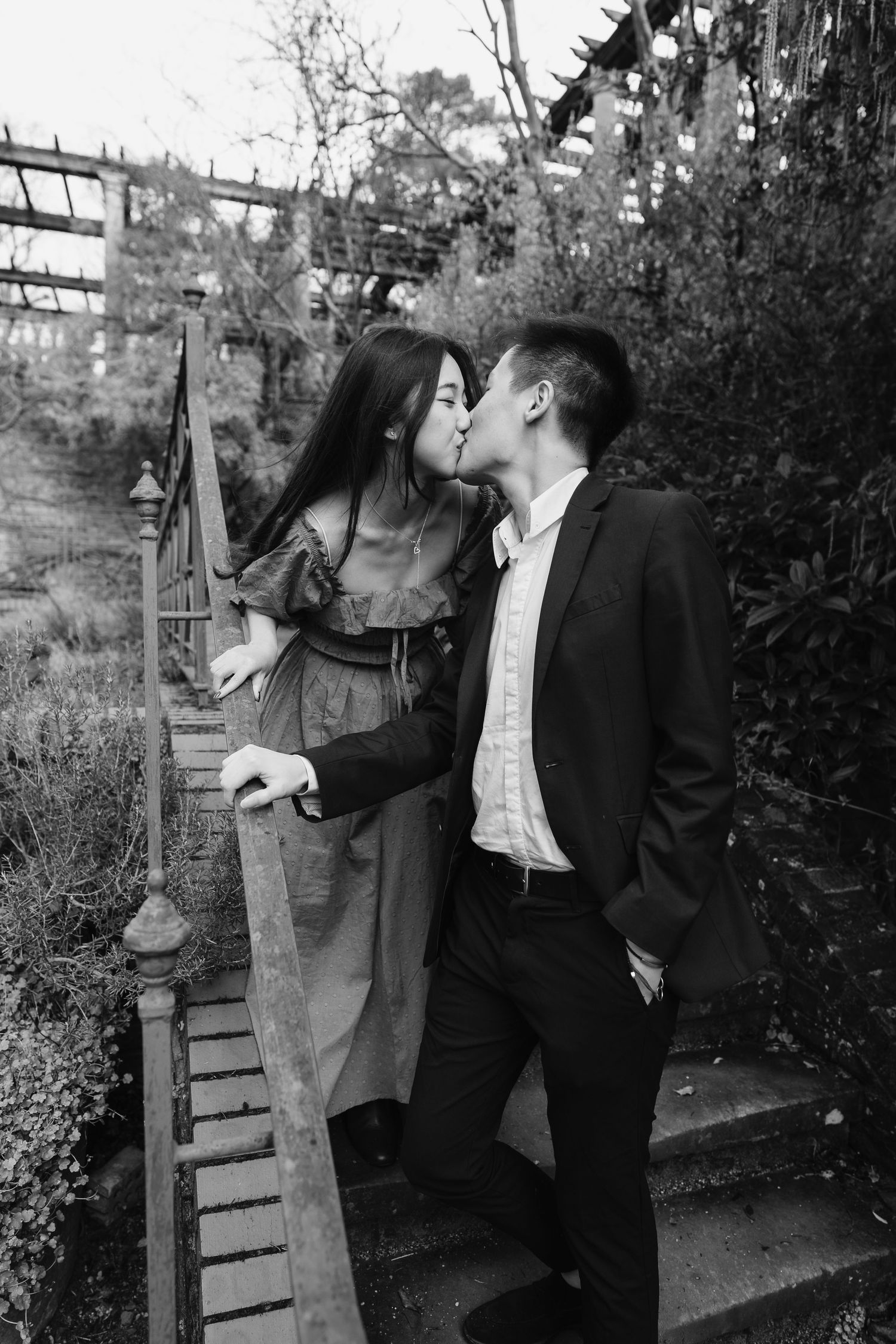 Black and White embrace captured on the pergola steps, romantic and natural, love photographing in London Hamstead Heath