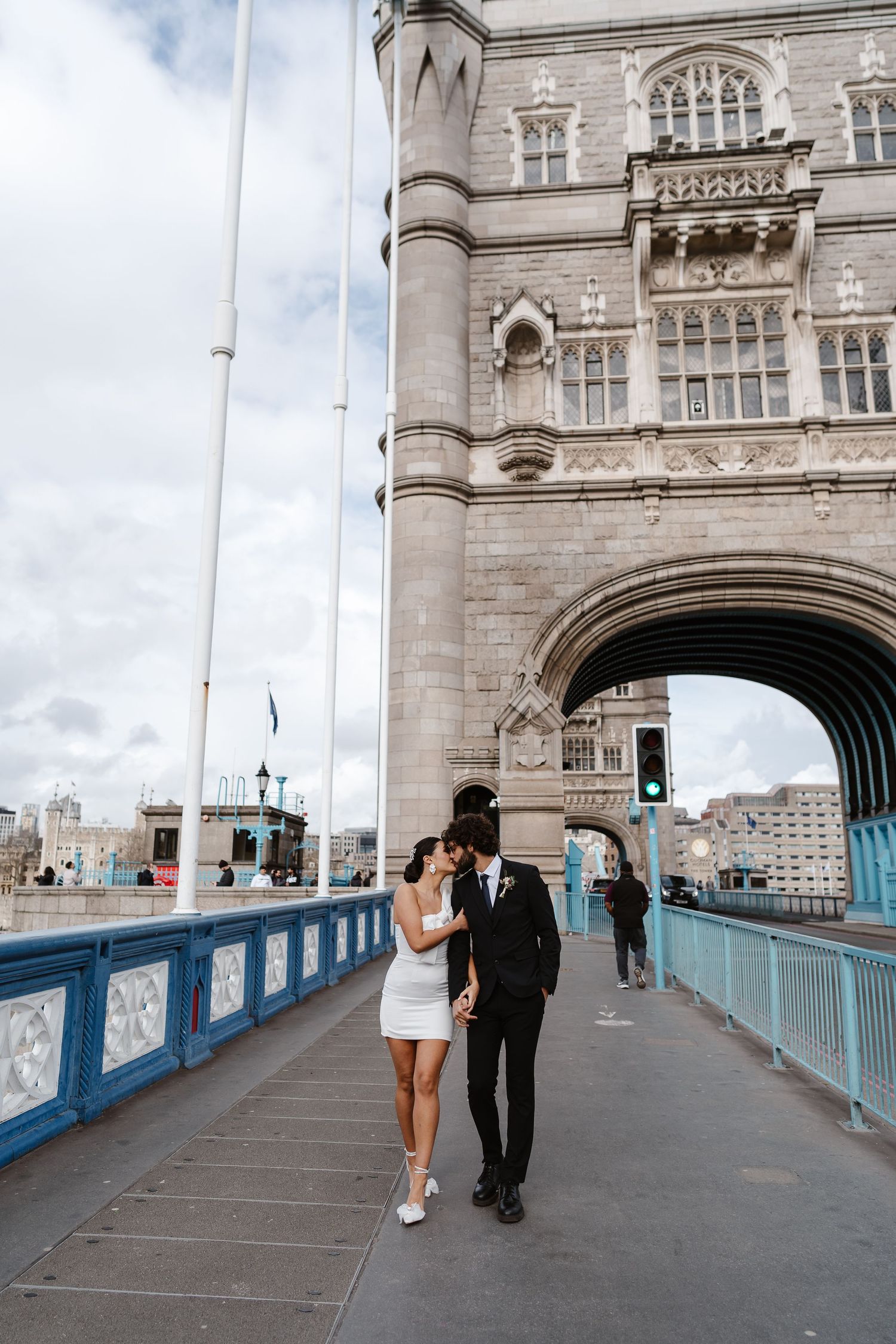 Luxury wedding photos at Tower Bridge. Bride short dress. Fun photos. Editorial. London Wedding Photographer. romantic