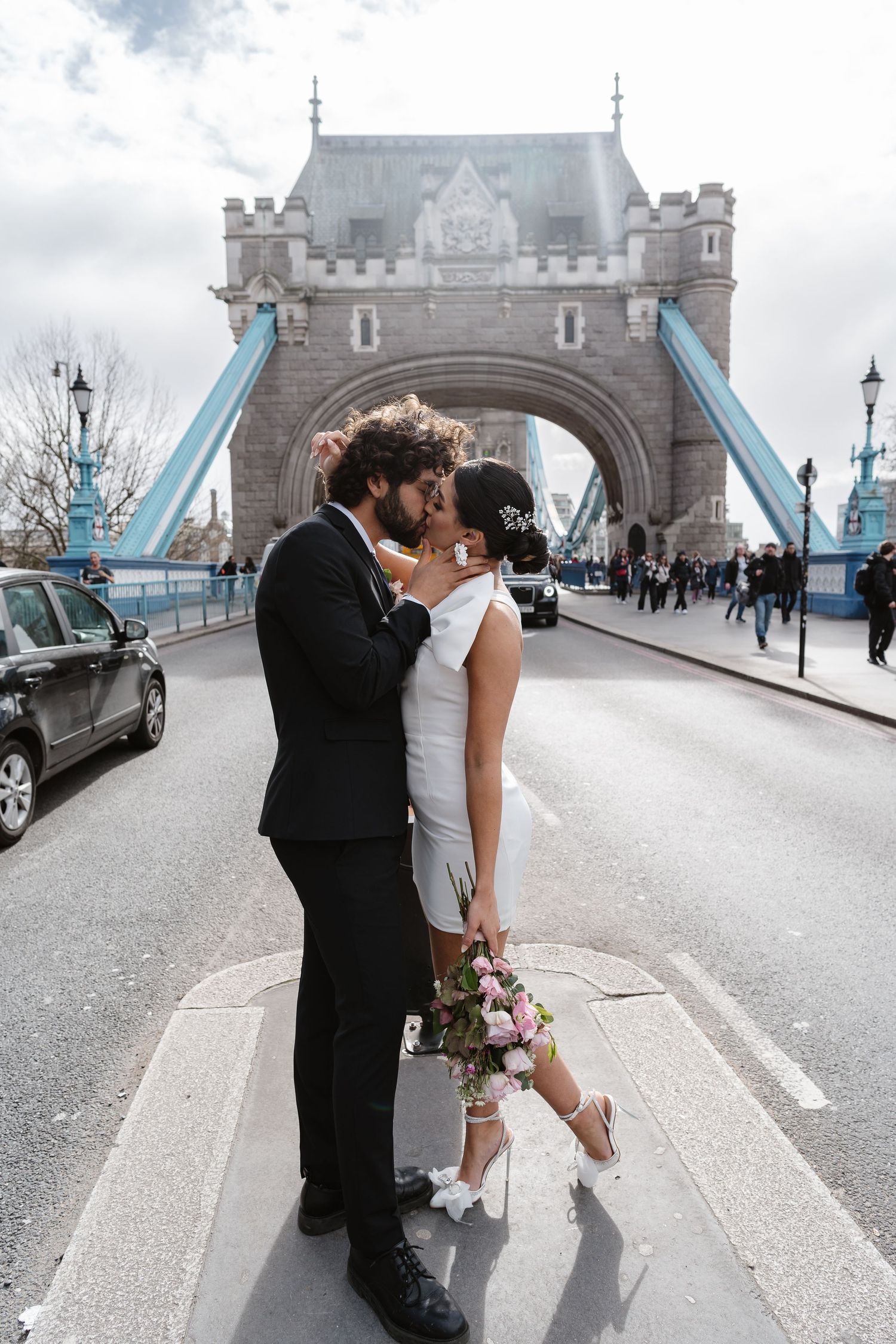 Luxury wedding photos at Tower Bridge. Bride short dress. Fun photos. Editorial. London Wedding Photographer. romantic