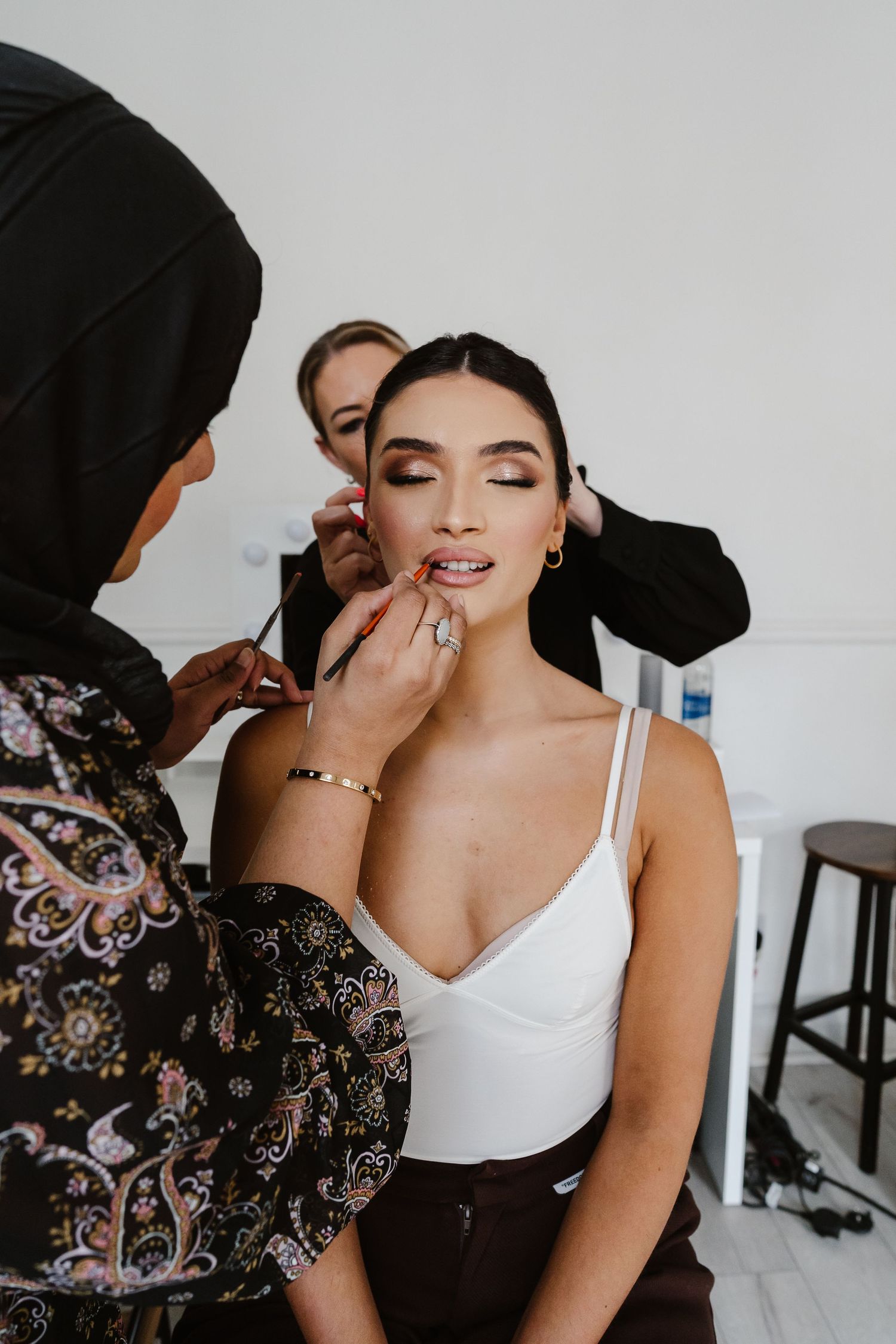Make up artist and Hair stylist during bridal prep in London St Paul's for Wedding bridal hair and make up. London Weddi