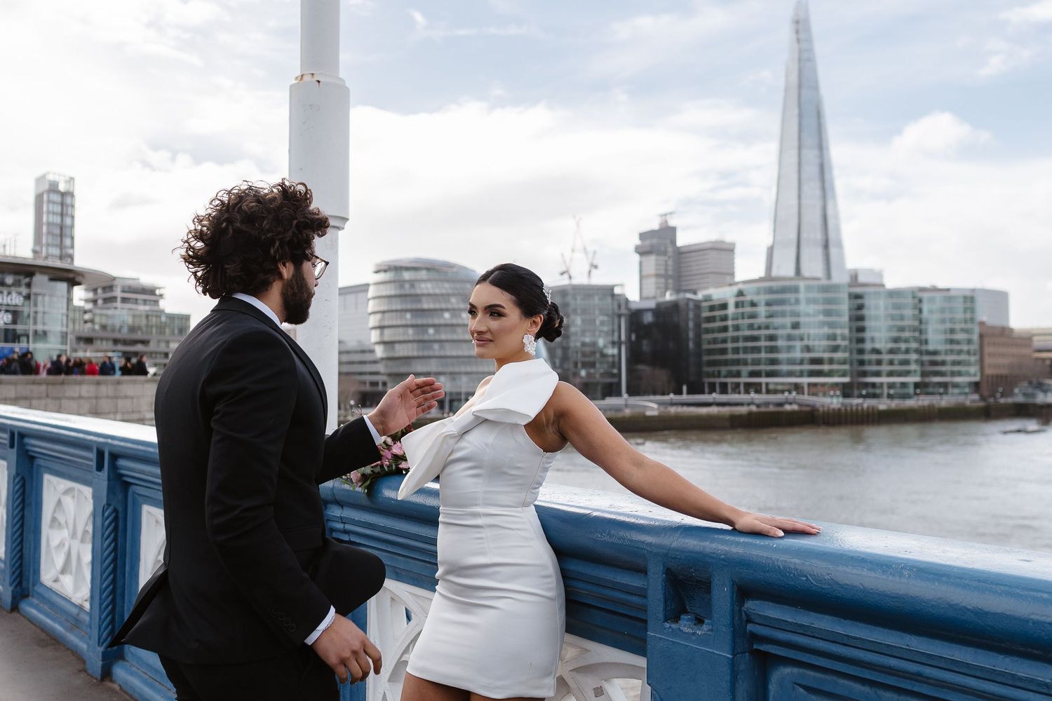 Luxury wedding photos at Tower Bridge. Bride short dress. Fun photos. The shard. Editorial. London Wedding Photographer