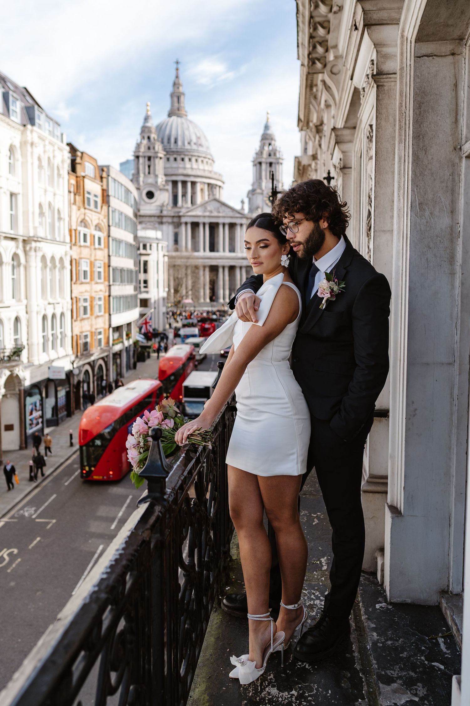Luxury Bride & Groom on Parisian-style balcony overlooking St Paul's Cathedral in London for his wedding elopement.