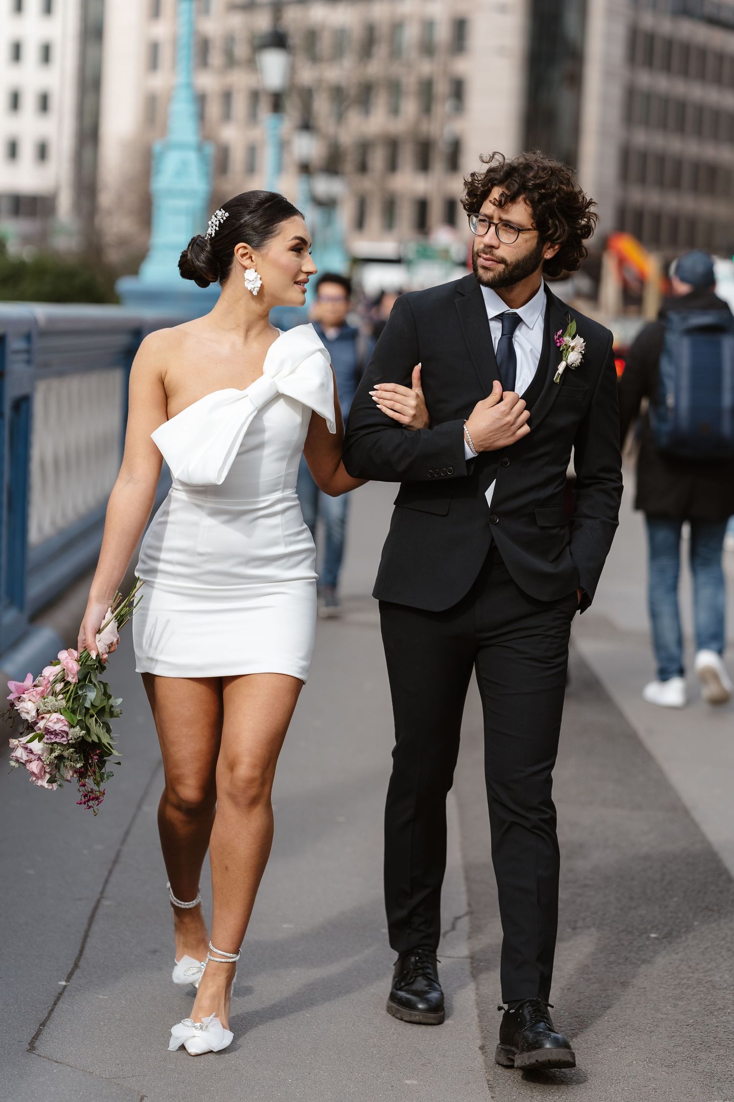Luxury wedding photos at Tower Bridge. Bride short dress. Fun photos. Editorial. London Wedding Photographer