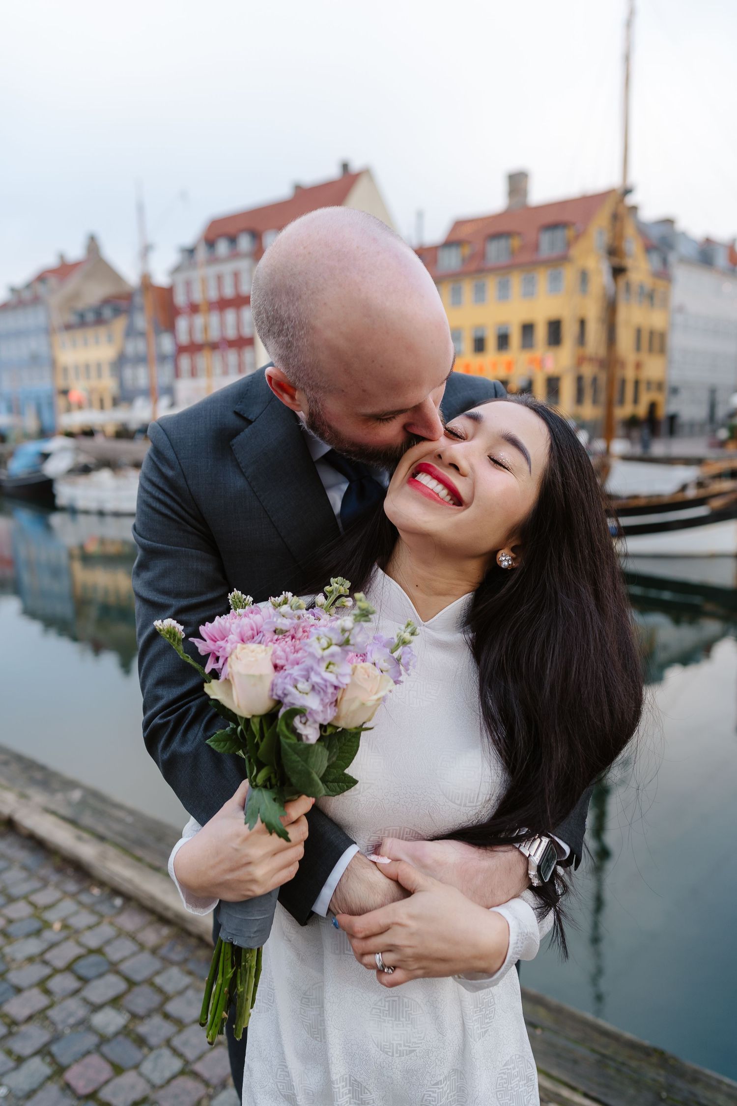 Newlyweds romantic along Nyhavn Canal in Copenhagen. Denmark wedding. Scandinavian & Destination Wedding Photographer