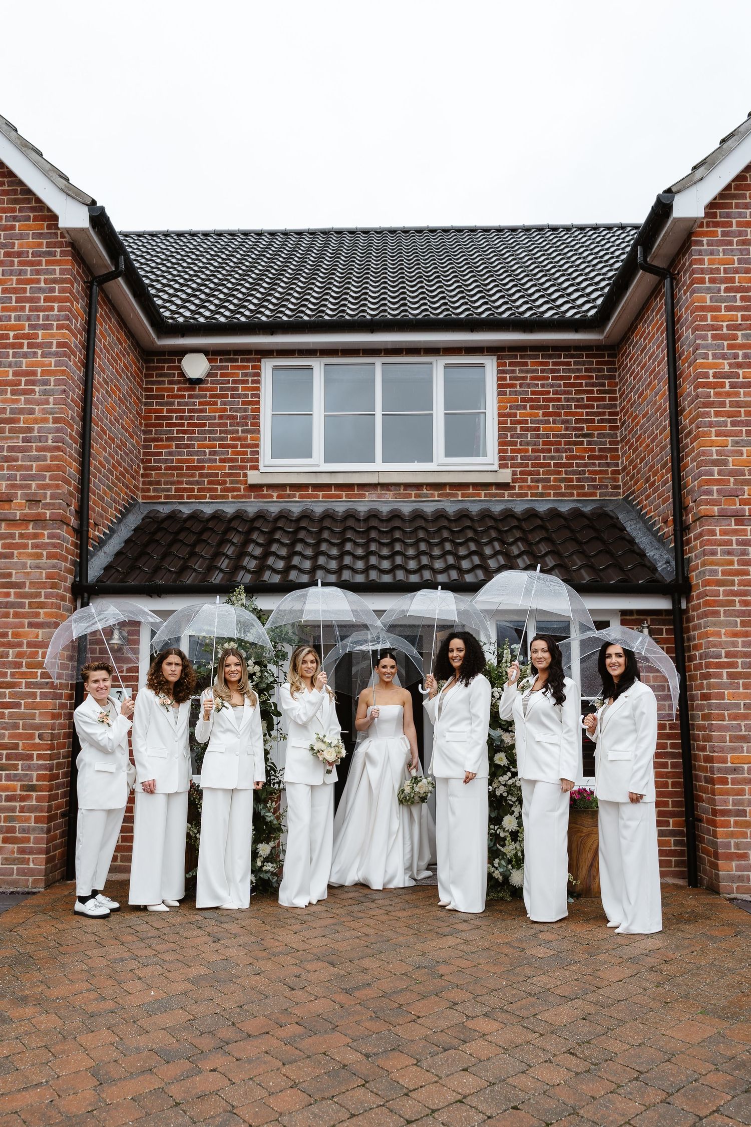Even the rain couldn't dampen this stylish wedding day with Bridesmaids rocking umbrellas. Rainy wedding day