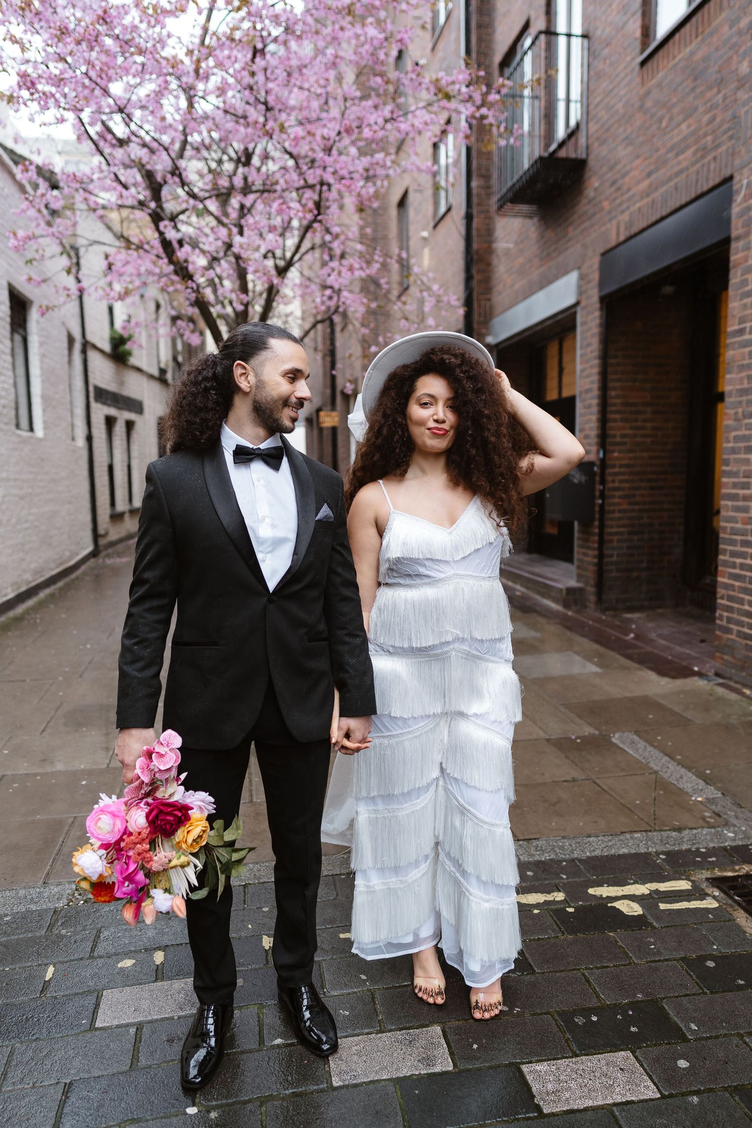Relaxed wedding couple at The Hoxton, Holborn. London Wedding Photographer.  vibrant bouquet flowers Pink blossom London
