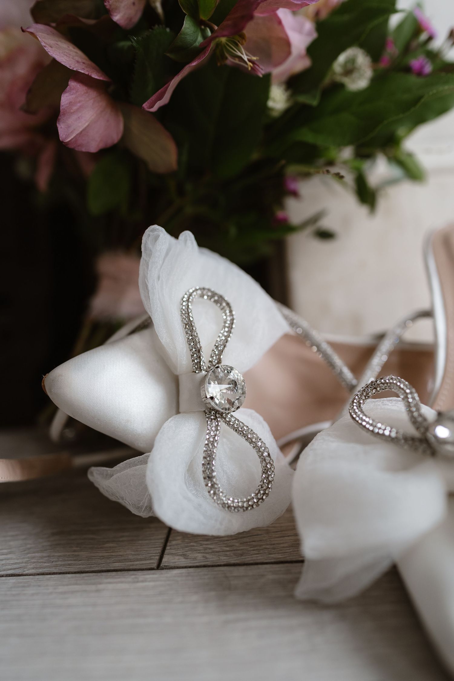 Wedding details. Dusky pink flowers bouquet and bridal shoes. London St Paul's for London Weddin