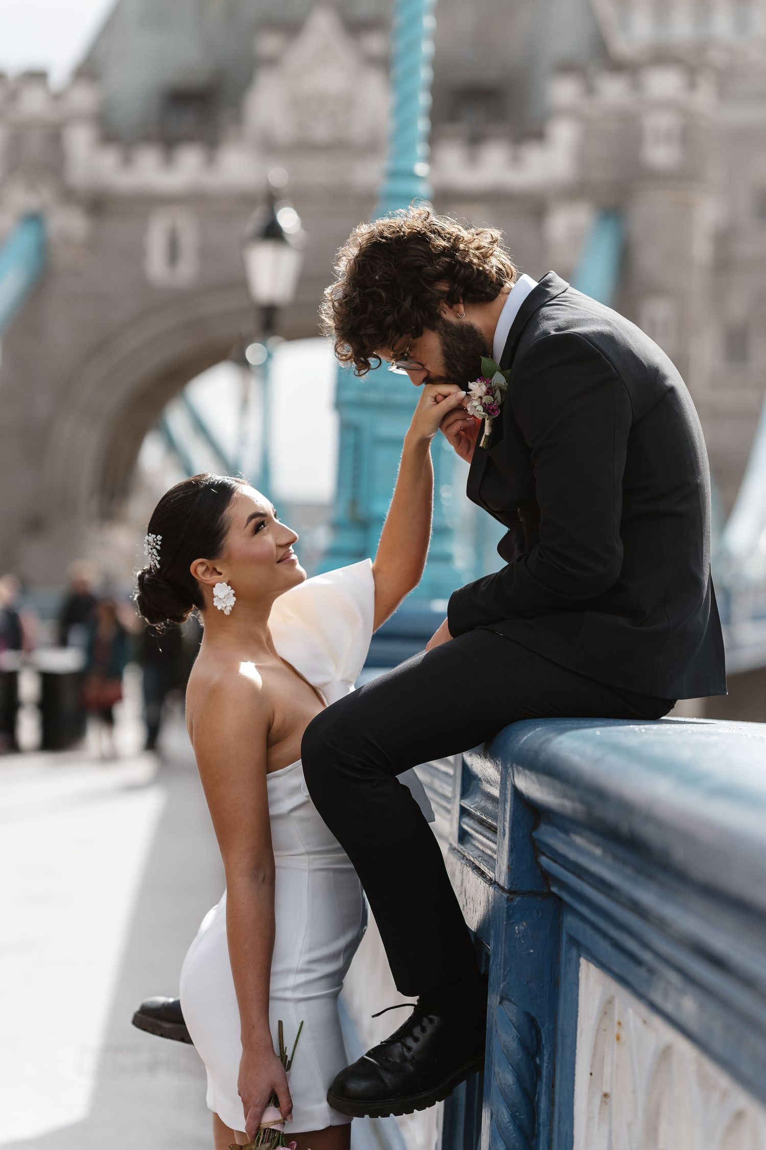 Luxury wedding photos at Tower Bridge. Bride short dress. Fun photos. Editorial. London Wedding Photographer. romantic