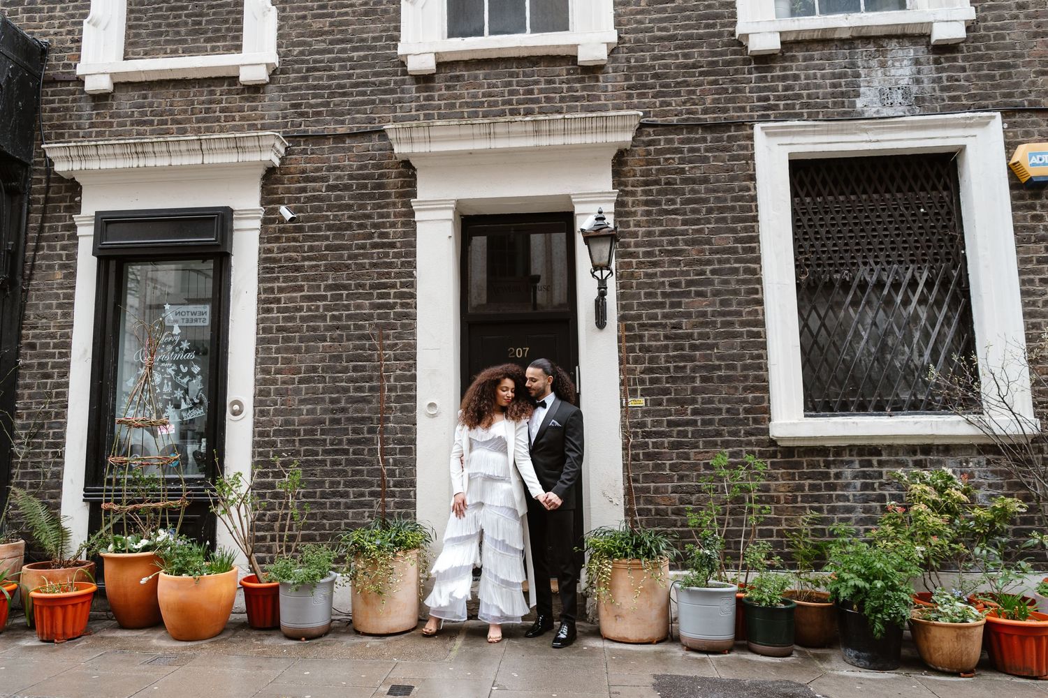 Relaxed wedding couple at The Hoxton, Holborn. London Wedding Photographer.  vibrant bouquet flowers