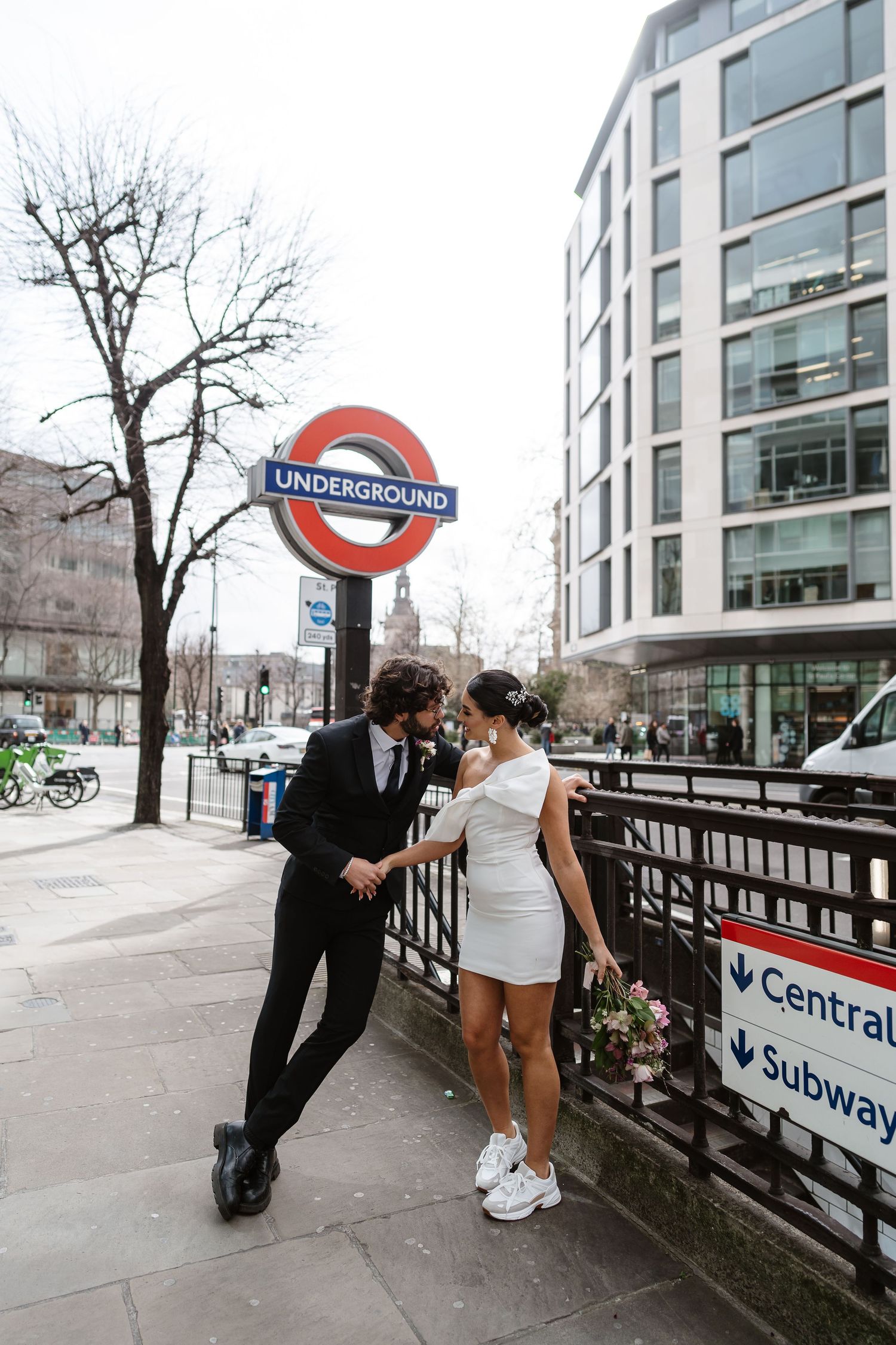 Bride and groom on London Underground tube wedding photos. Taken by London Wedding Photographer