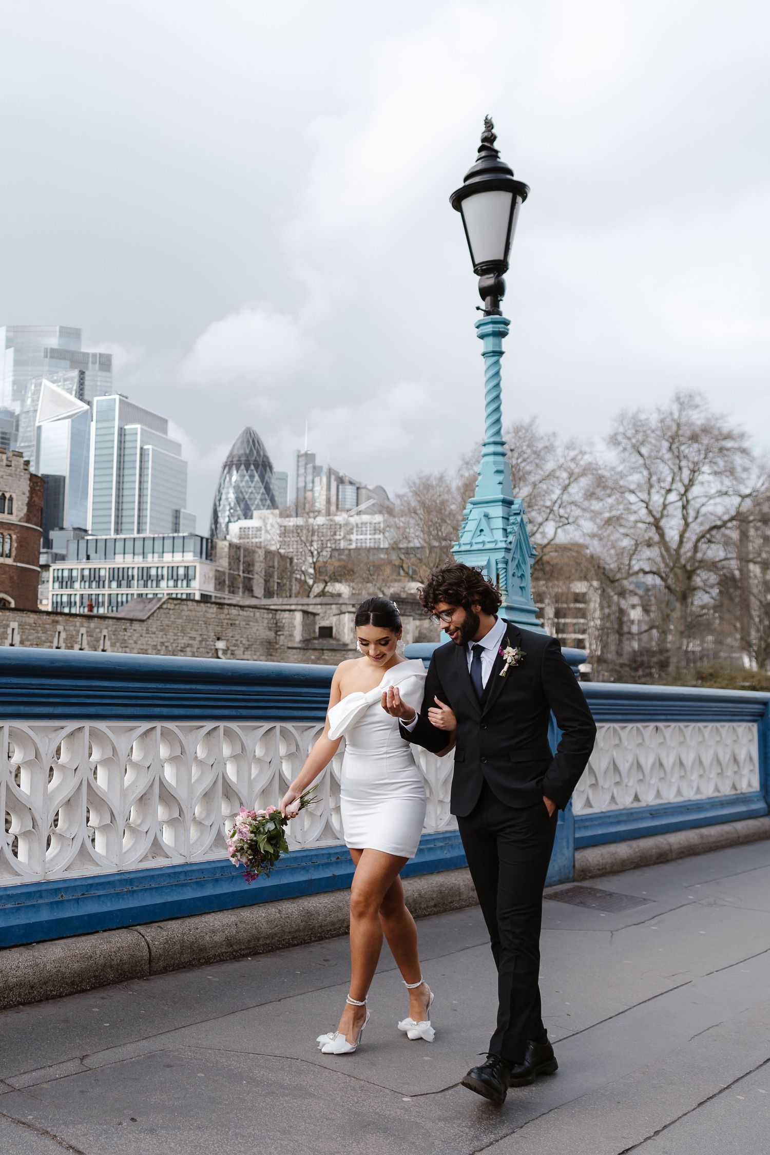 Luxury wedding photos at Tower Bridge. Bride short dress. Fun photos. Editorial. London Wedding Photographer