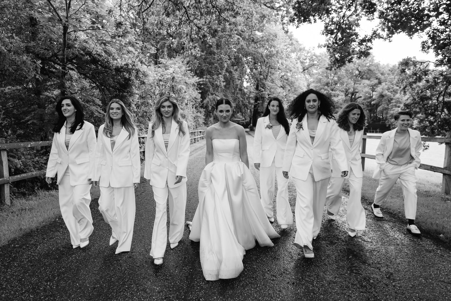 Here come the girls! Bridesmaids making a statement in white suits with their bestie bride. Norfolk wedding photographer