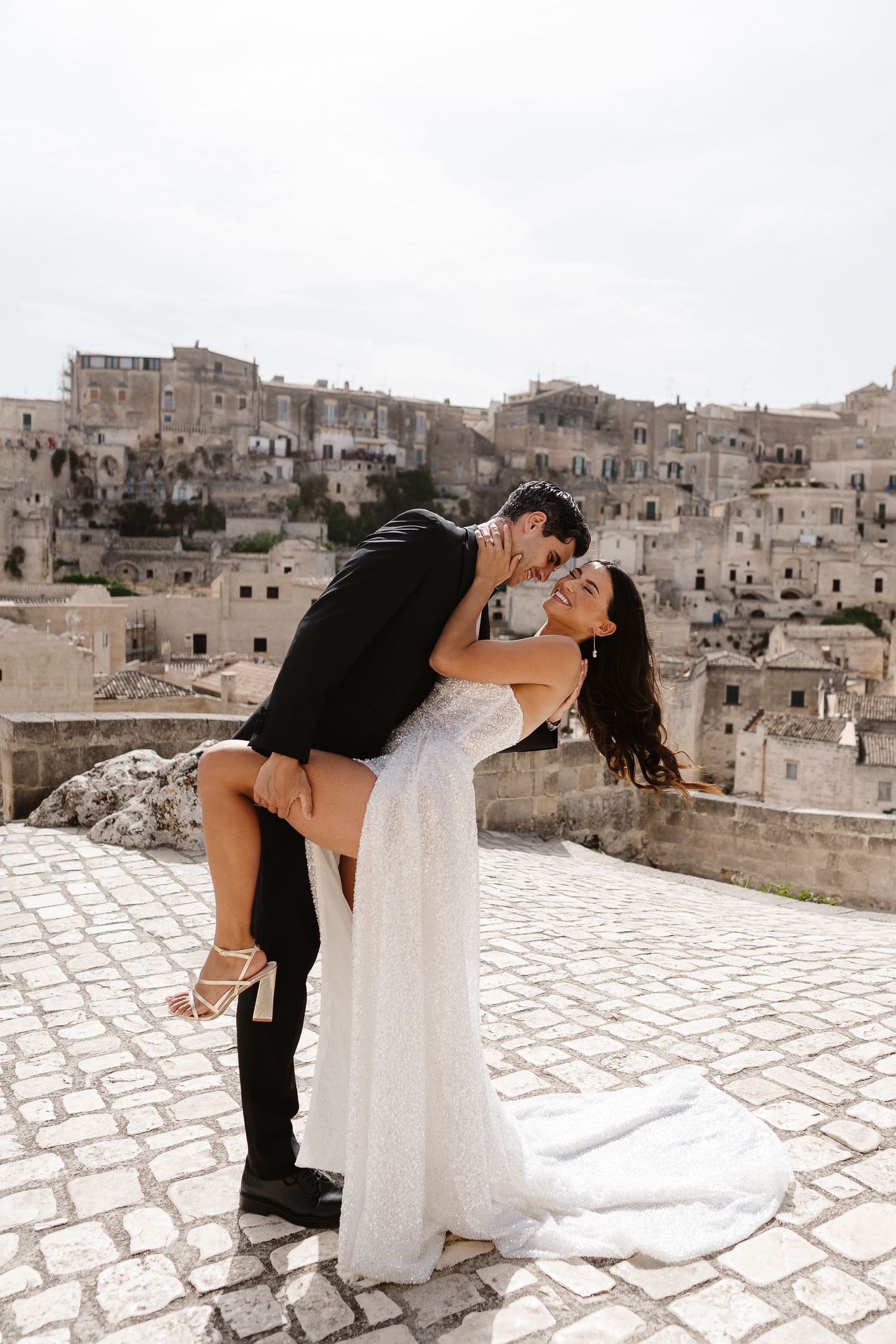 Giggly flirty fun, on the cobble street overlooking the old town - Matera