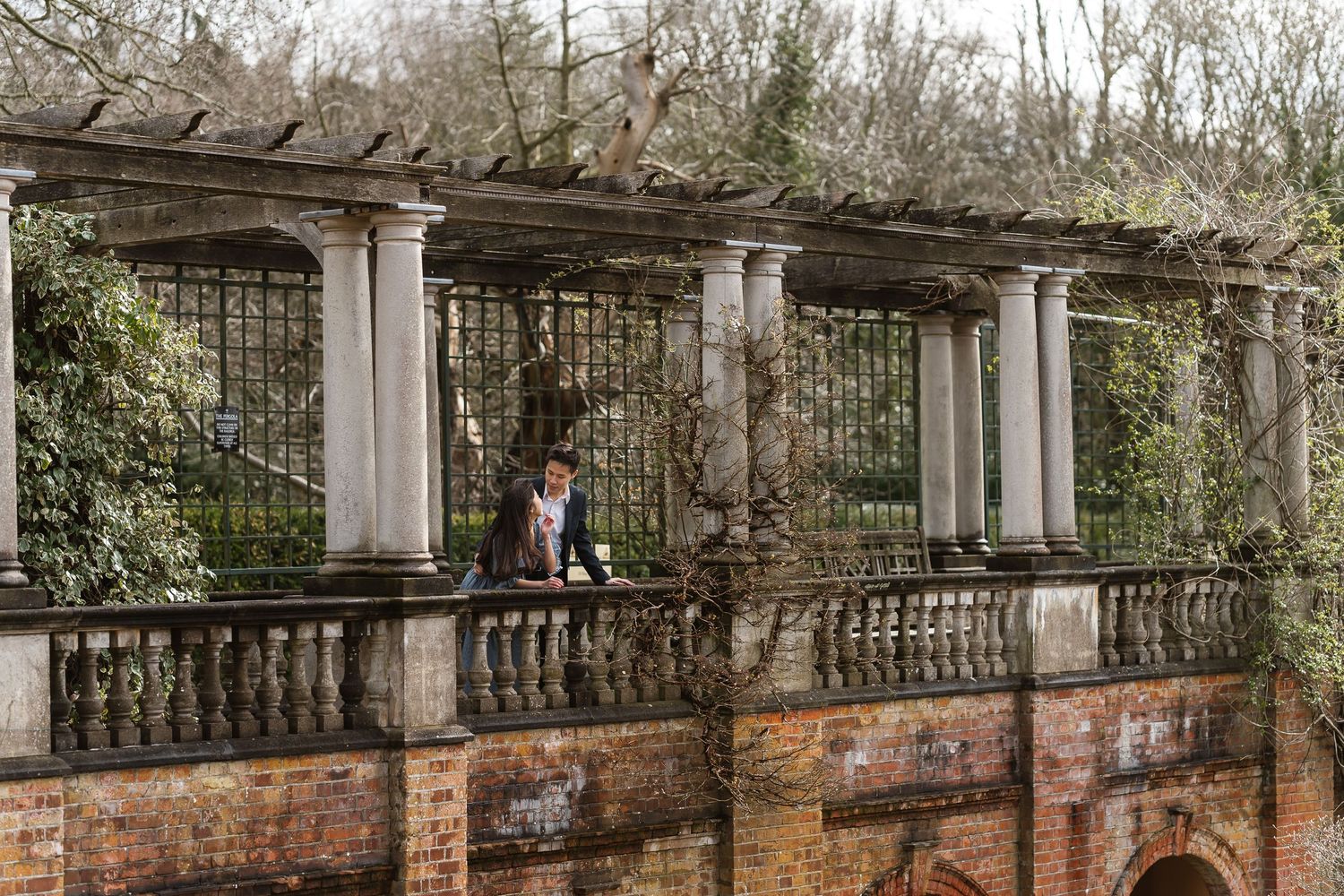 Chilled enjoying the sunshine on the pergola Hampstead Heath, London engagement photographer