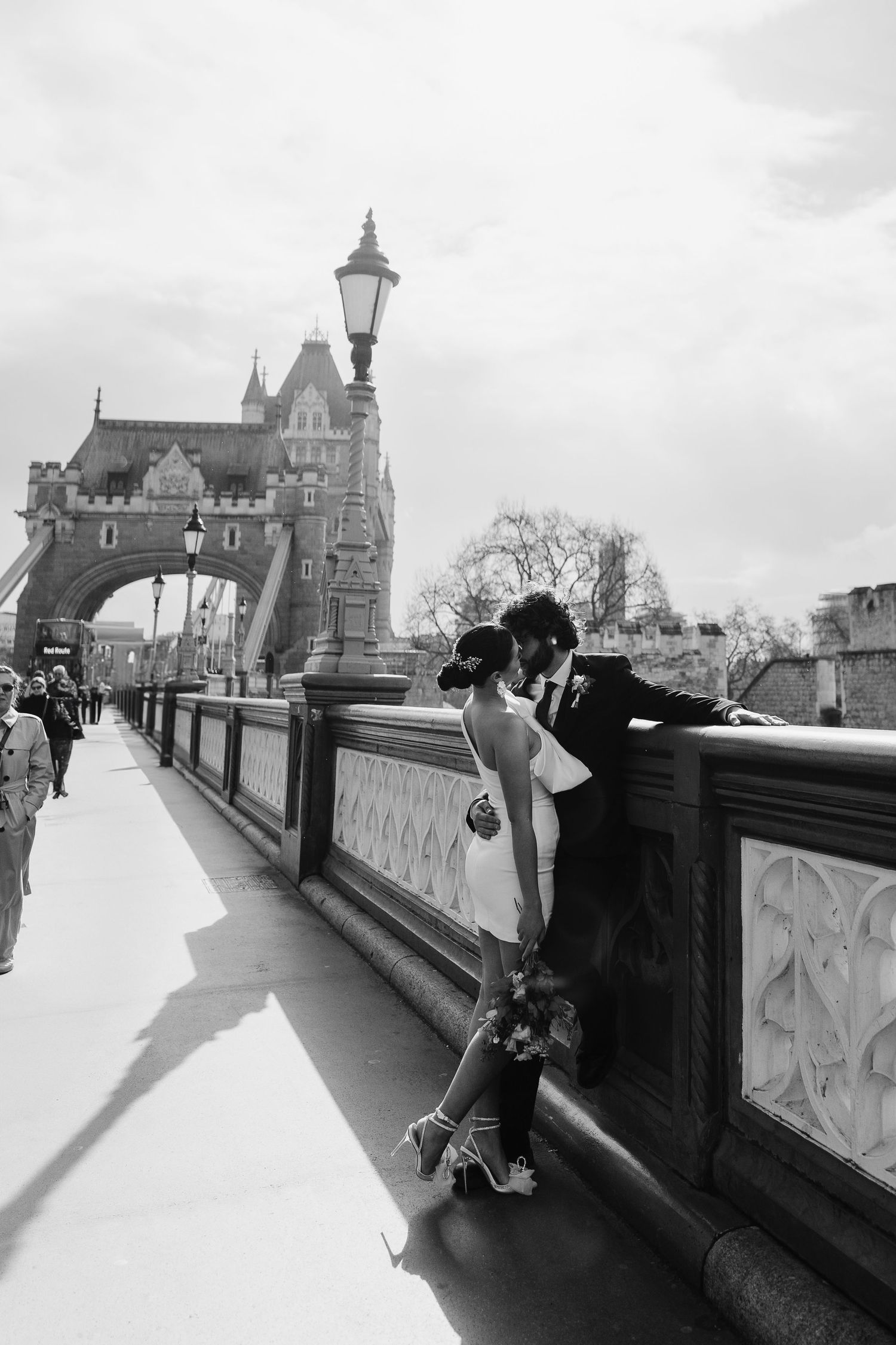 Luxury wedding photos at Tower Bridge. Bride short dress. Fun photos. Editorial. London Wedding Photographer. romantic