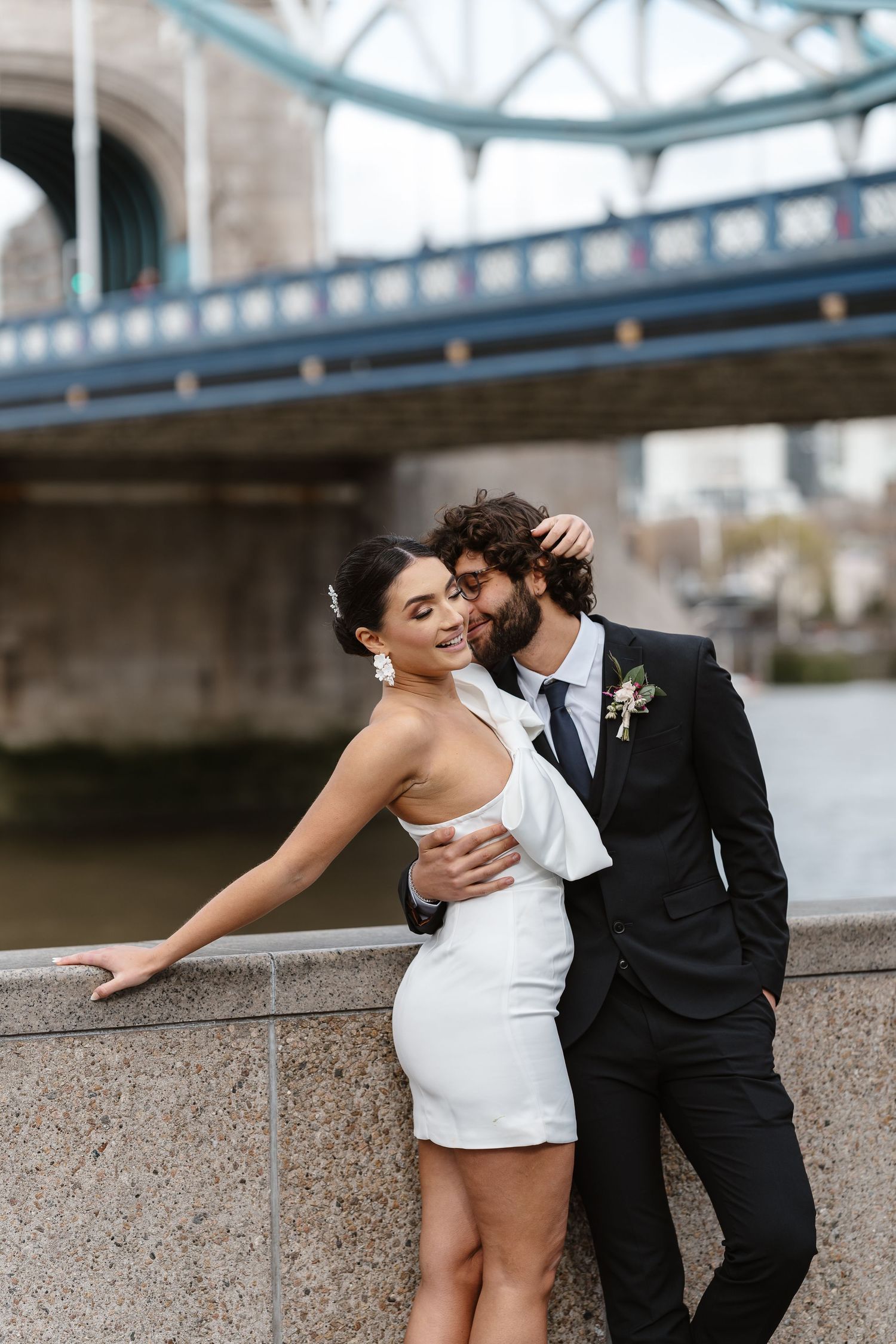 Luxury wedding photos at Tower Bridge. Bride short dress. Fun photos. Editorial. London Wedding Photographer