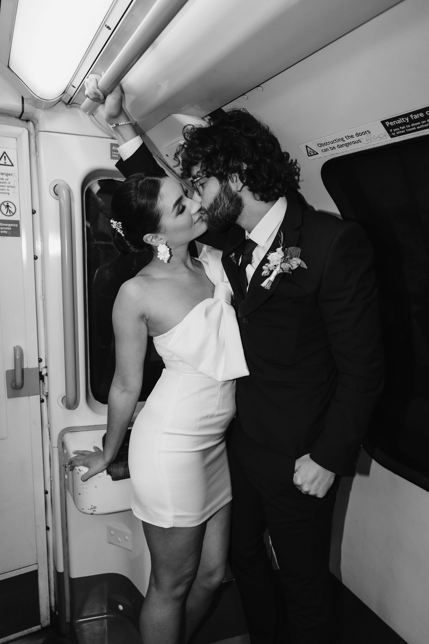bride and groom in the London Underground Tube, direct flash editorial photography. Modern fun wedding photos. London