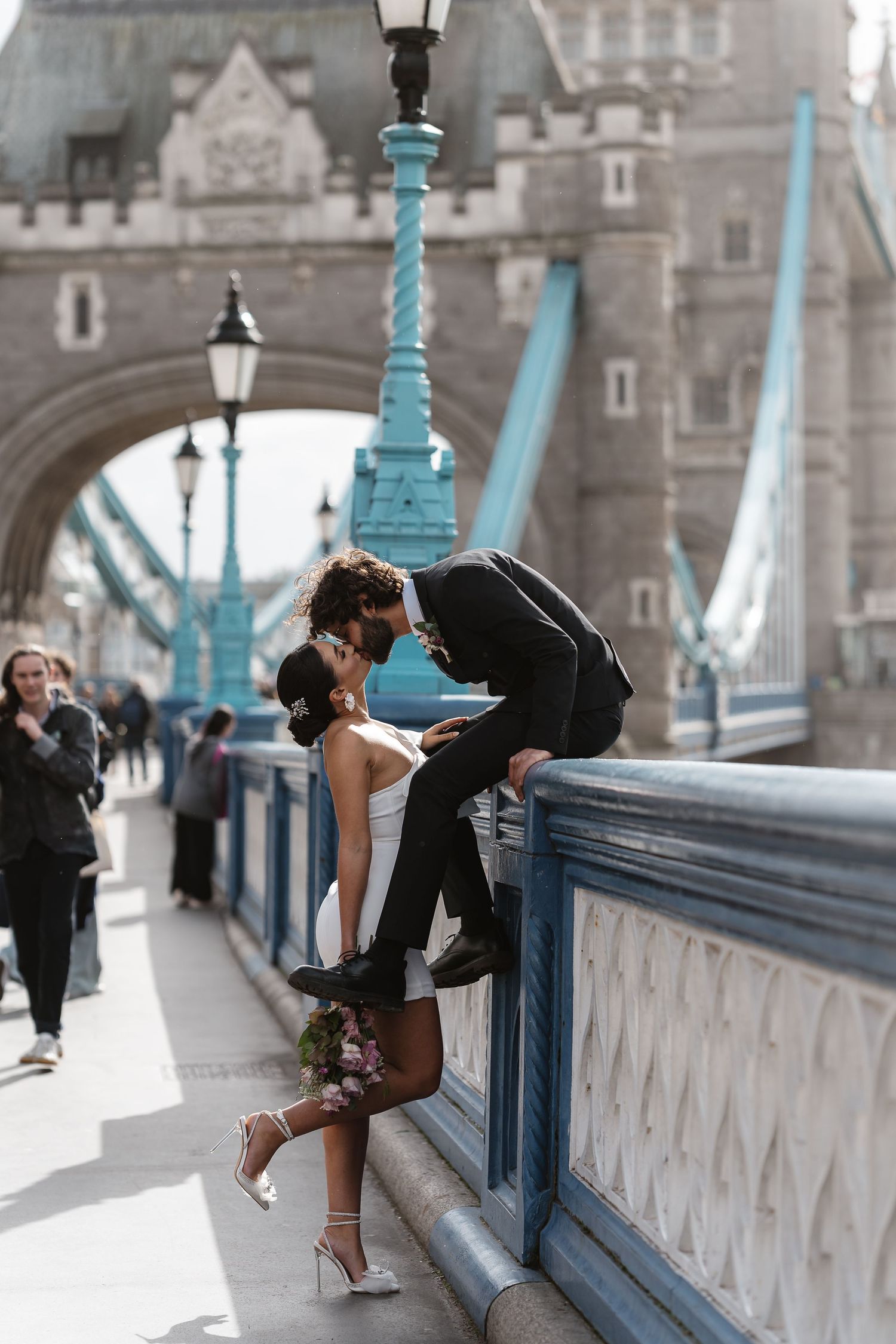Luxury wedding photos at Tower Bridge. Bride short dress. Fun photos. Editorial. London Wedding Photographer. romantic