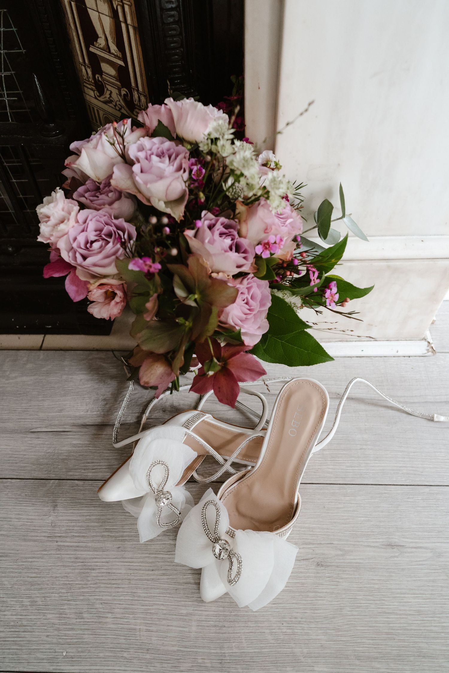 Wedding details. Dusky pink flowers bouquet and bridal shoes. London St Paul's for London Weddin